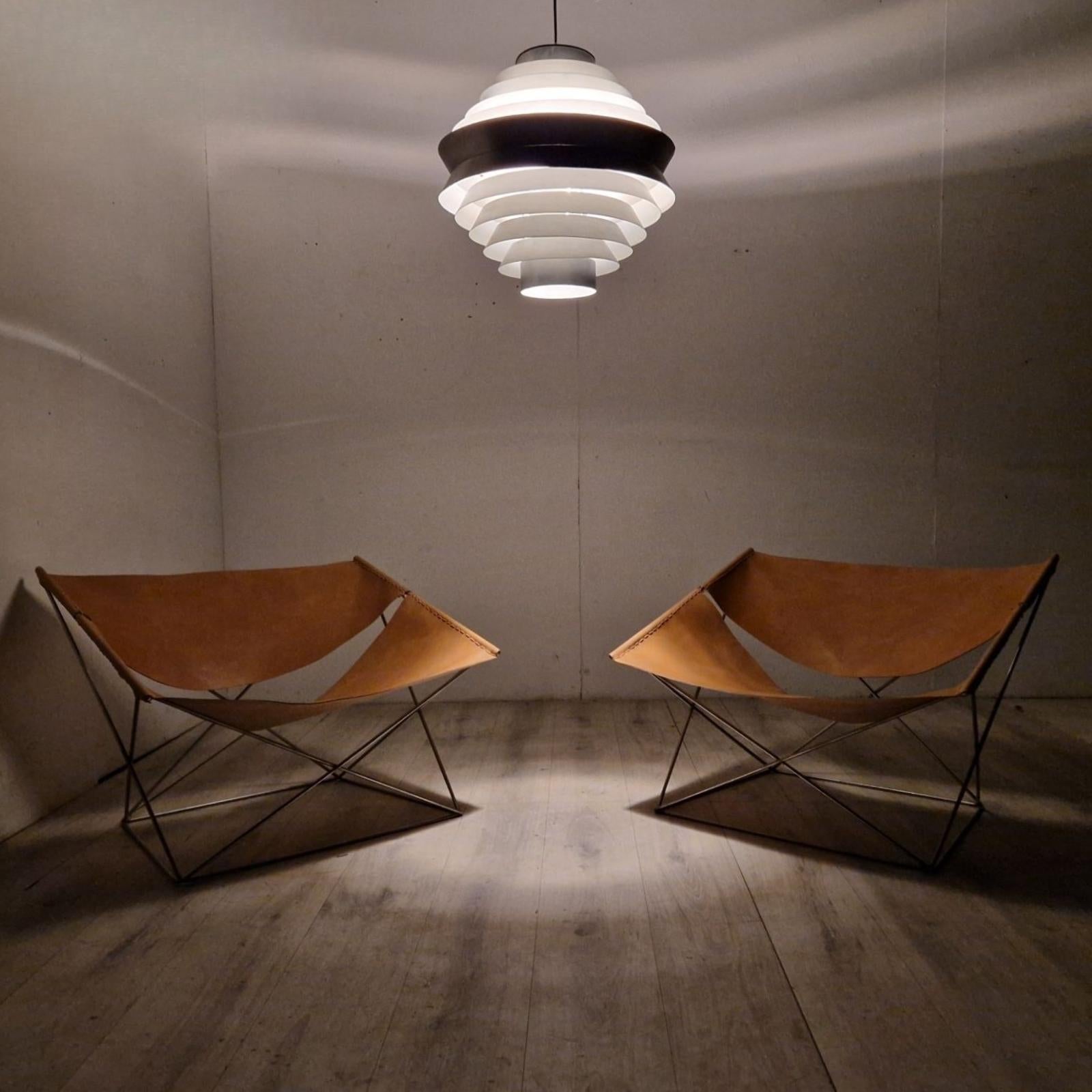 Amazing set of 2 F-675 lounge chairs. Designed in 1964 by Pierre Paulin and produced by Artifort. They have a minimalist metal wire frame with thick cognac saddle leather seat and back. These were re-upholstered according to original specifications.