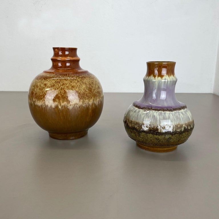 Article:

Ceramic pottery vase set of 2


Origin:

Germany, GDR


Producer:

Strehla, Germany GDR


Decade:

1970s


This original vintage pottery objects was designed and produced by Strehla in the 1970s in East Germany, GDR. It