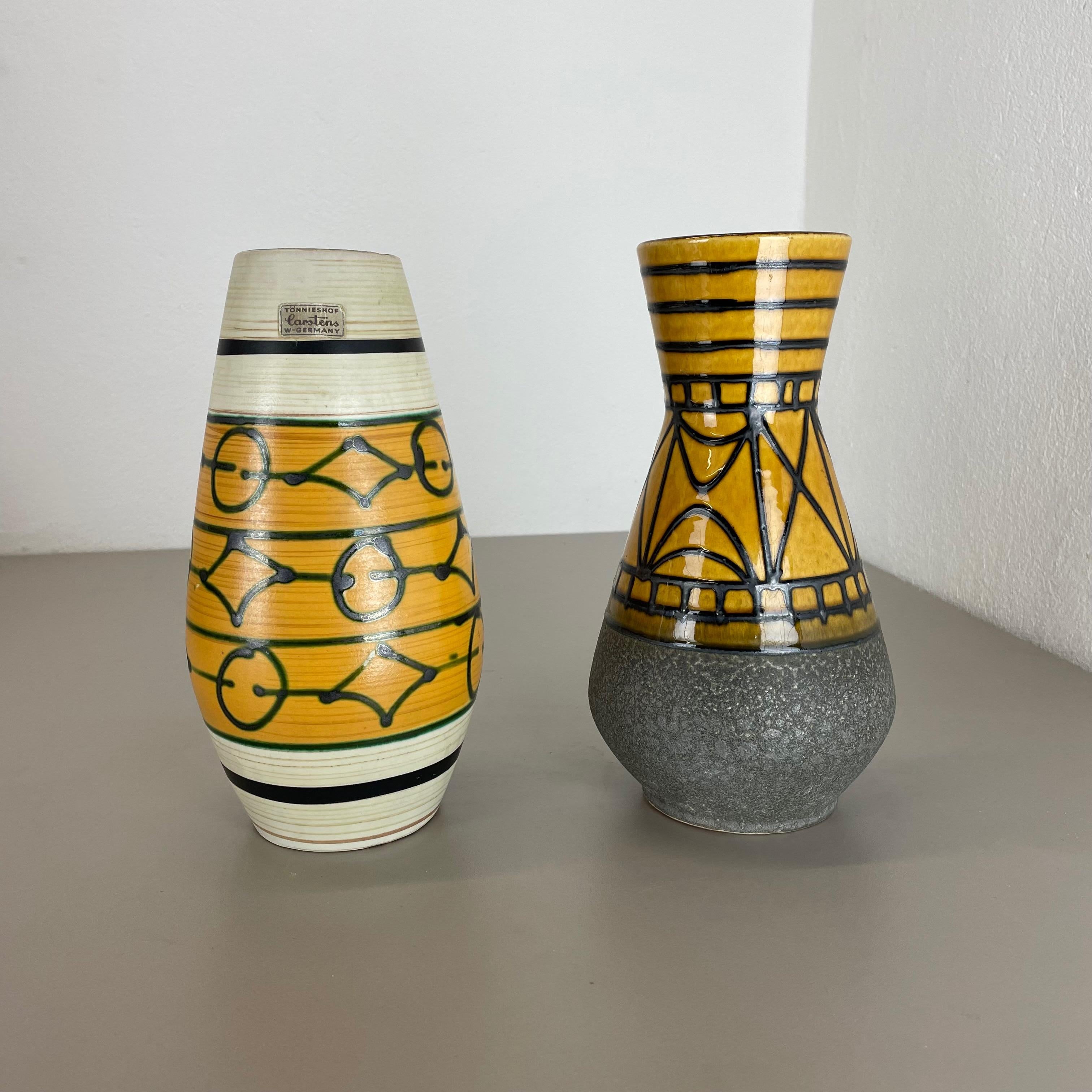 Article:

Ceramic pottery vases set of 2.


Origin:

Germany


Designer:

Heinz Siery


Producer:

Carstens Tönnieshof, Germany


Decade:

1970s


This original vintage pottery object set was designed by Heinz Siery and