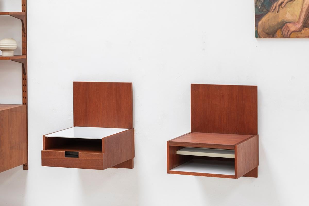 Set of floating night stands, designed by Cees Braakman and produced by Pastoe in the Netherlands around 1960. The cabinet with a drawer is finished in teak veneer with a white milk-glass top. The other cabinet has a mirror. In very good condition