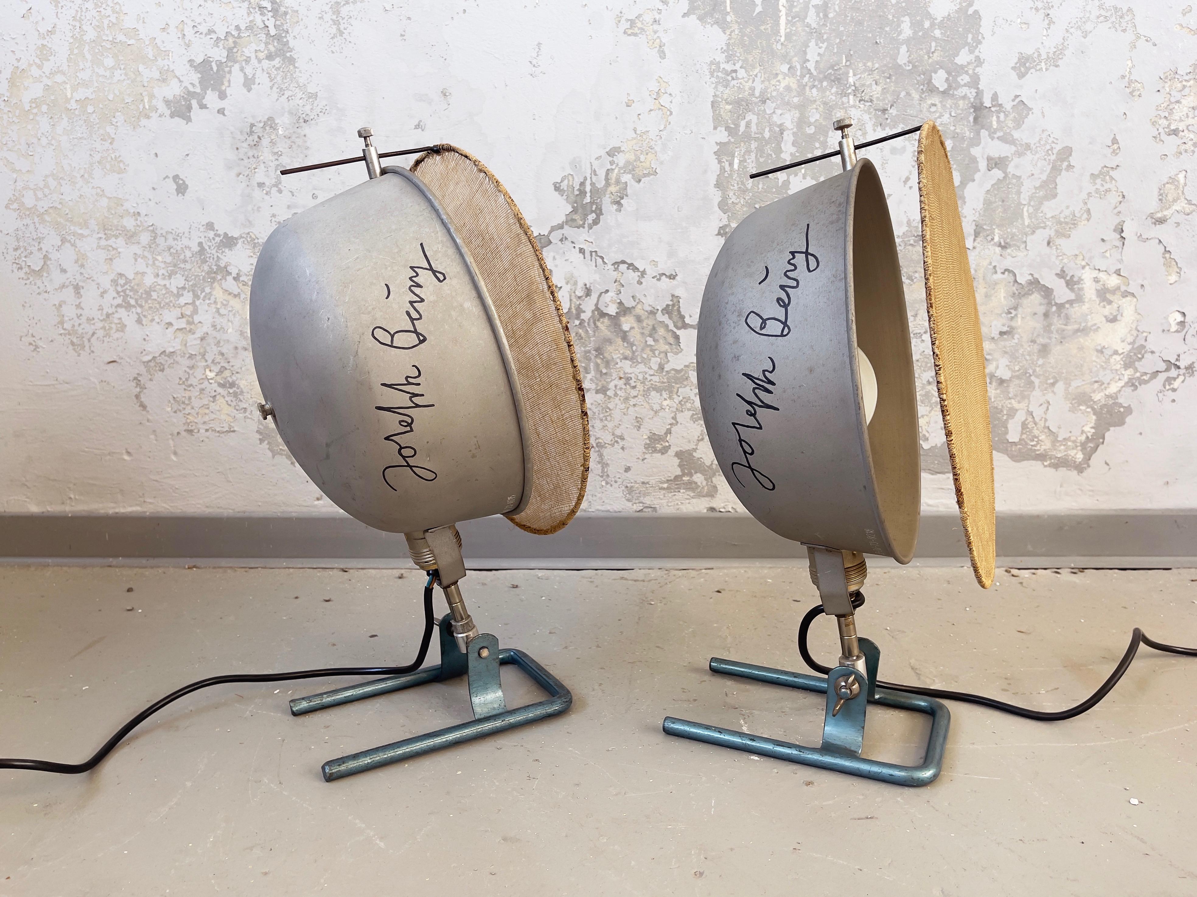 Fantastic old industrial style photo-studio floor lamps by unknown maker, Germany.
These are made around 1955-1965 from metal incl. reflector, and come with clearly custom made, adjustable and 
hand woven flax or linen screens.
The bases show a blue