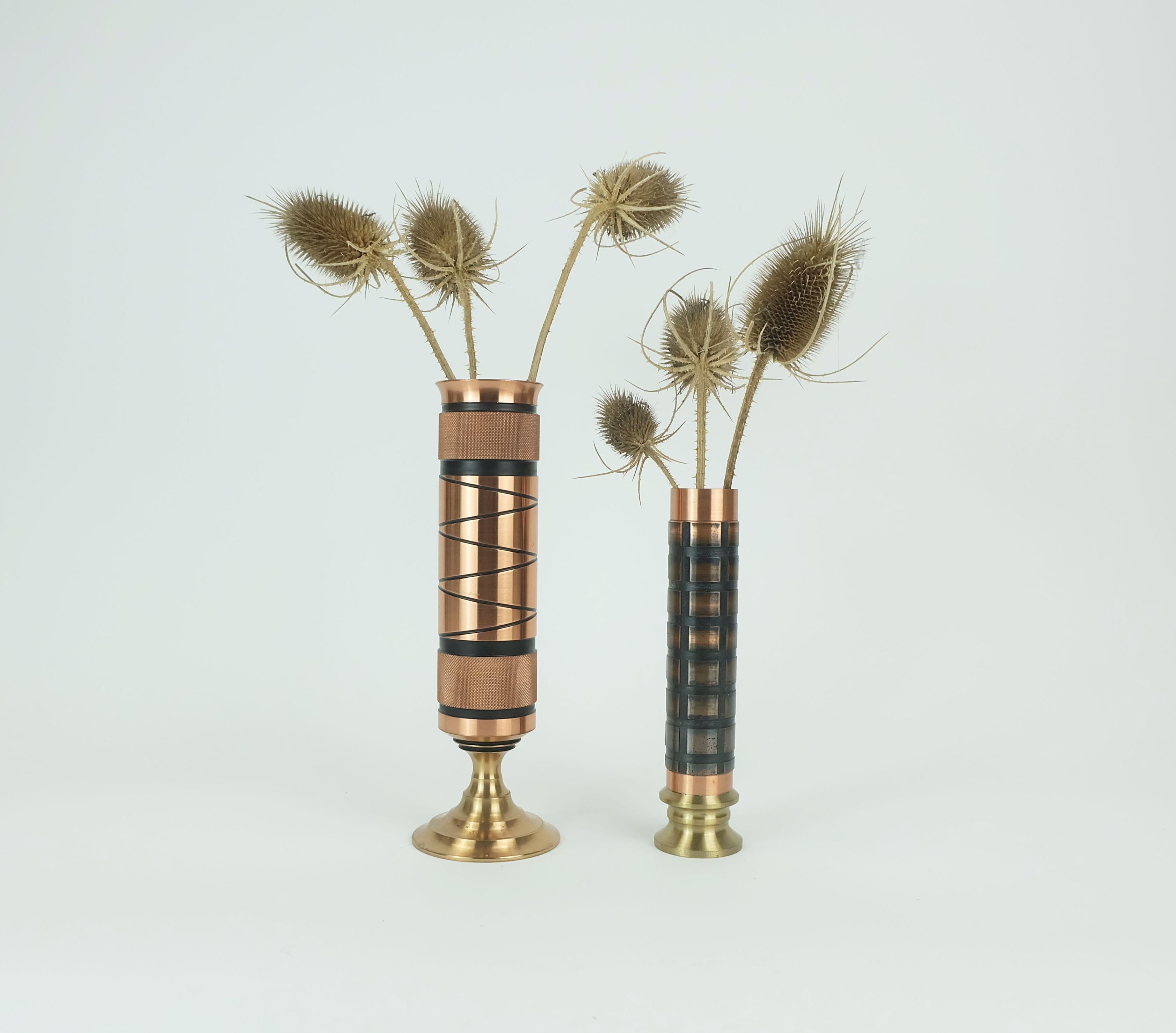 A pair of very beautiful and outstanding 1960s danish modern mid century vases. Made of copper with a relief decor in black. Different decors that fit together very well. Each stand made of brass. Brutalist minimalist design. A perfect addition to