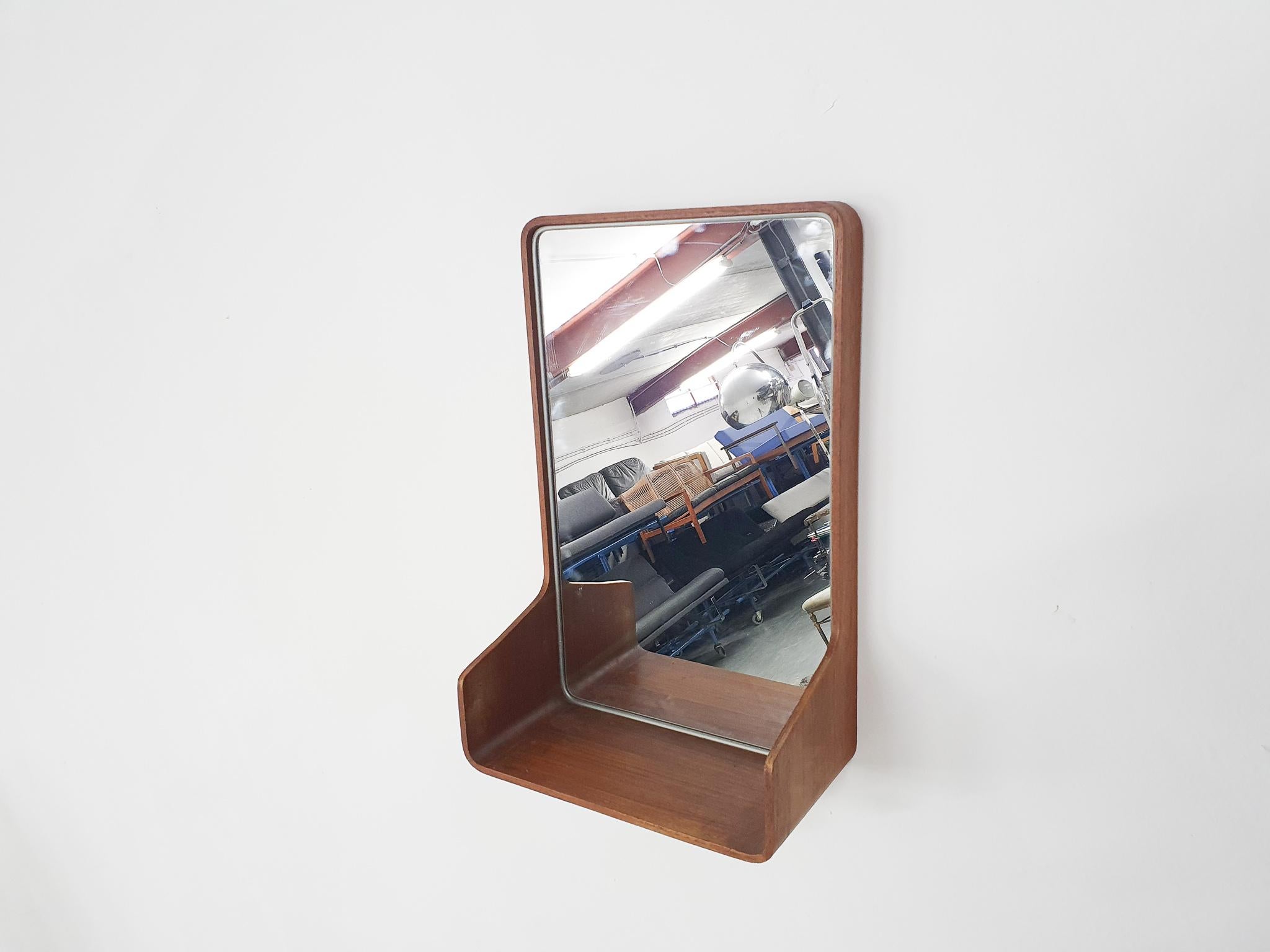 Set of 2 Plywood mirrors designed by Friso Kramer for Auping. One with a glass shelf and space to store items and one without the glass shelf.
The plywood has some normal traces of use.

Friso Kramer
Kramer is the son of architect Piet Kramer. In