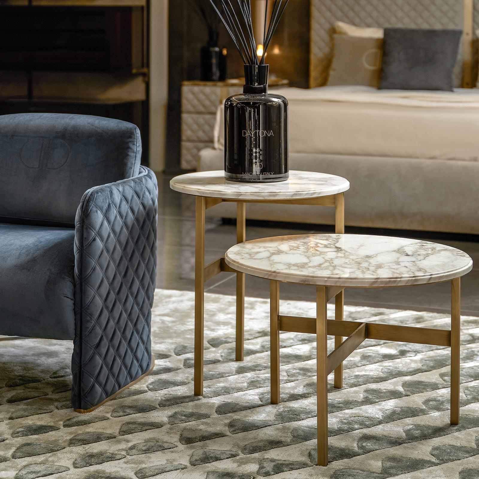 A clean and elegant design characterize this set of two Gaudi side tables. With legs finished in burnished brass or titanium and tops in marble, the stylish tables will compliment any contemporary or classic decor. This version features the striking