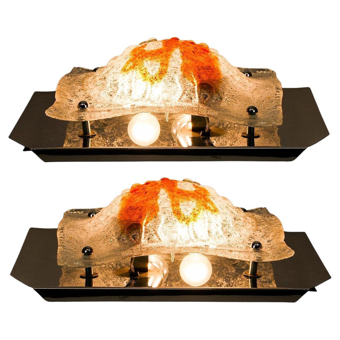 Pair of Amber Glass Bullicante Wall Sconces By Mazzega Murano Toni Zuccheri Attr
Large sized wall lamps from the 1960s.
Blown glass diffusers in clear and amber colour, with a domed and textured bullicante surface.
Set on a polished steel base.
The