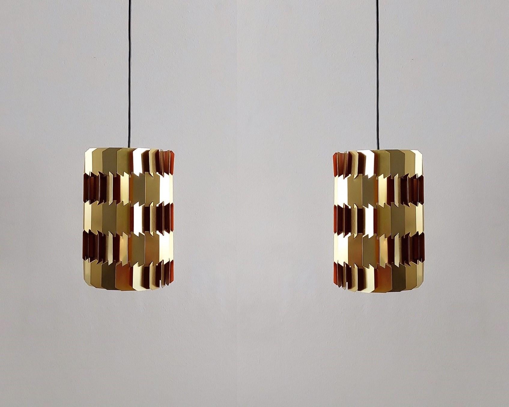 The 'Facet-pop' pendant lamp was designed by Louis Weisdorf for Lyfa in Denmark in the 1960's. It is made out of many small metal parts that are put together. The dynamic layered shape is a true signature of Weisdorf. It has a gold coloured outside