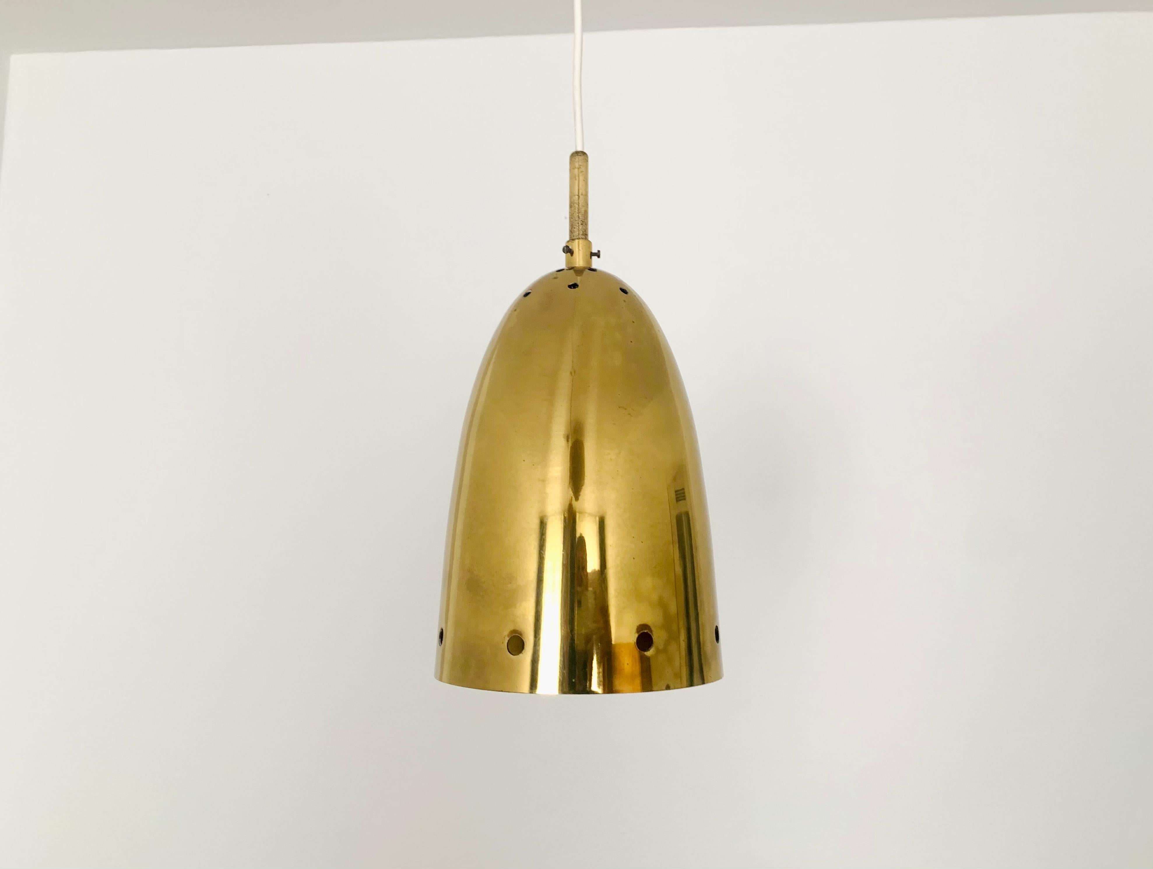 Beautiful gold pendant lamp with decorative holes from the 1950s.
The design and the materials create a fantastic play of light in the room.
Very loving processing and an enrichment for every home.

Condition:

Very good vintage condition with signs