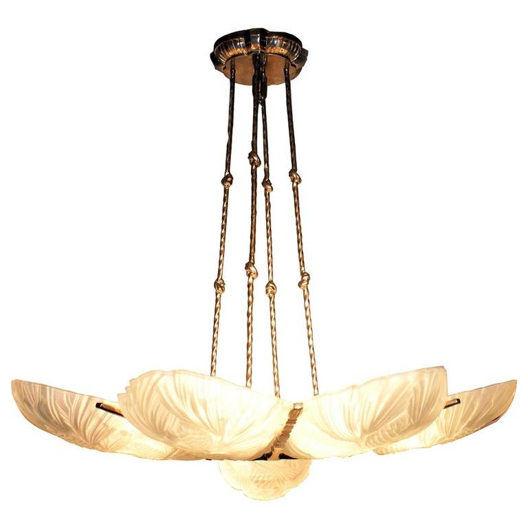 Set of 2 large French Art Deco chandelier by Marius Ernest Sabino, having eight clear frosted glass panels featuring: pine cone shade beaming a center glass bowl with floral pine design.
Accommodate with nine household bulbs of 60 watts each, for a