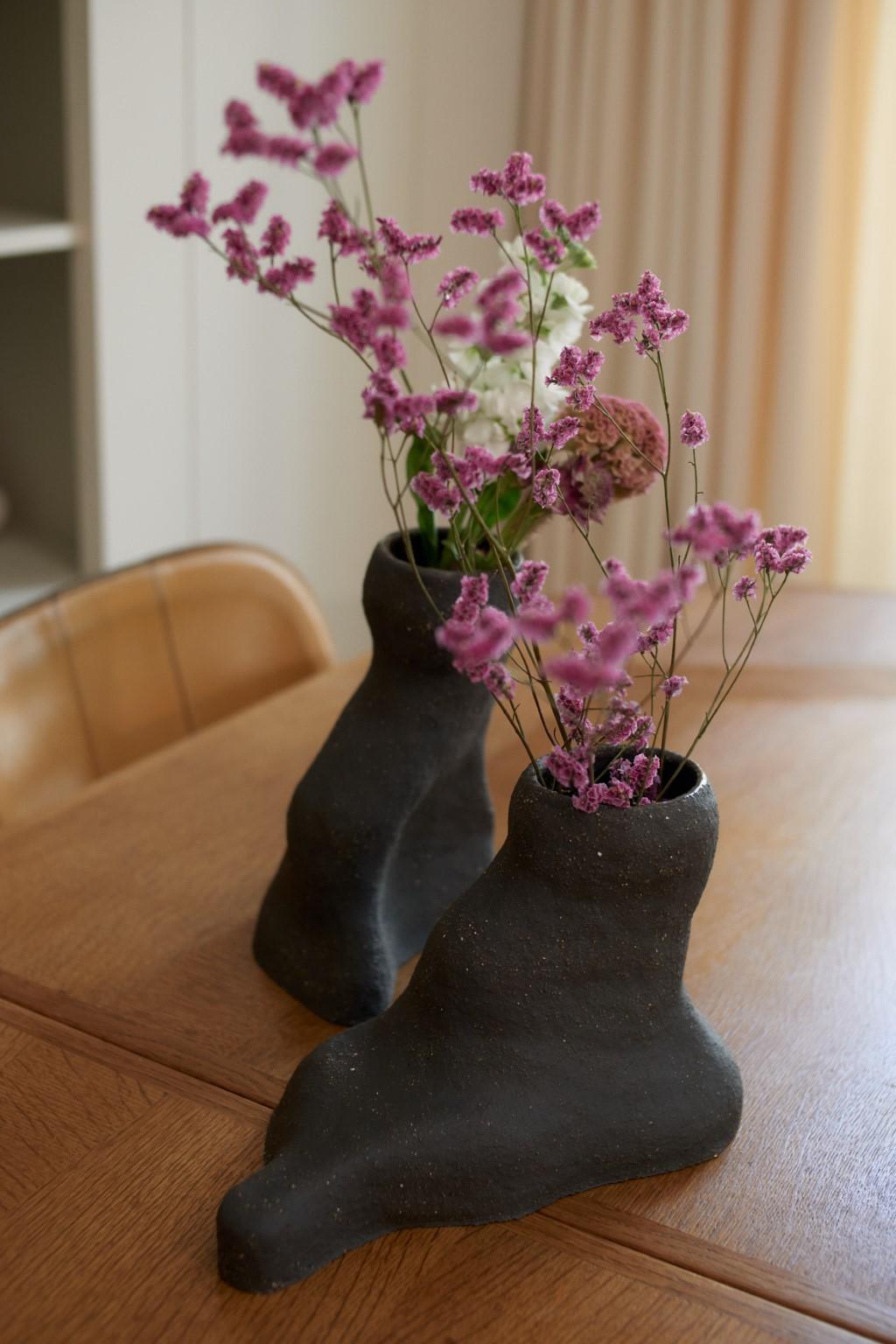 Set of 2 Granite Duo vases by Sophie Parachey
Dimensions: W 23 x D 14 x H 33 cm, W 26 x D 13 x H 18 cm
Materials: Black textured stoneware (large chamotte).

Inspired by extended stays in Central America, Sophie Parachey’s work questions