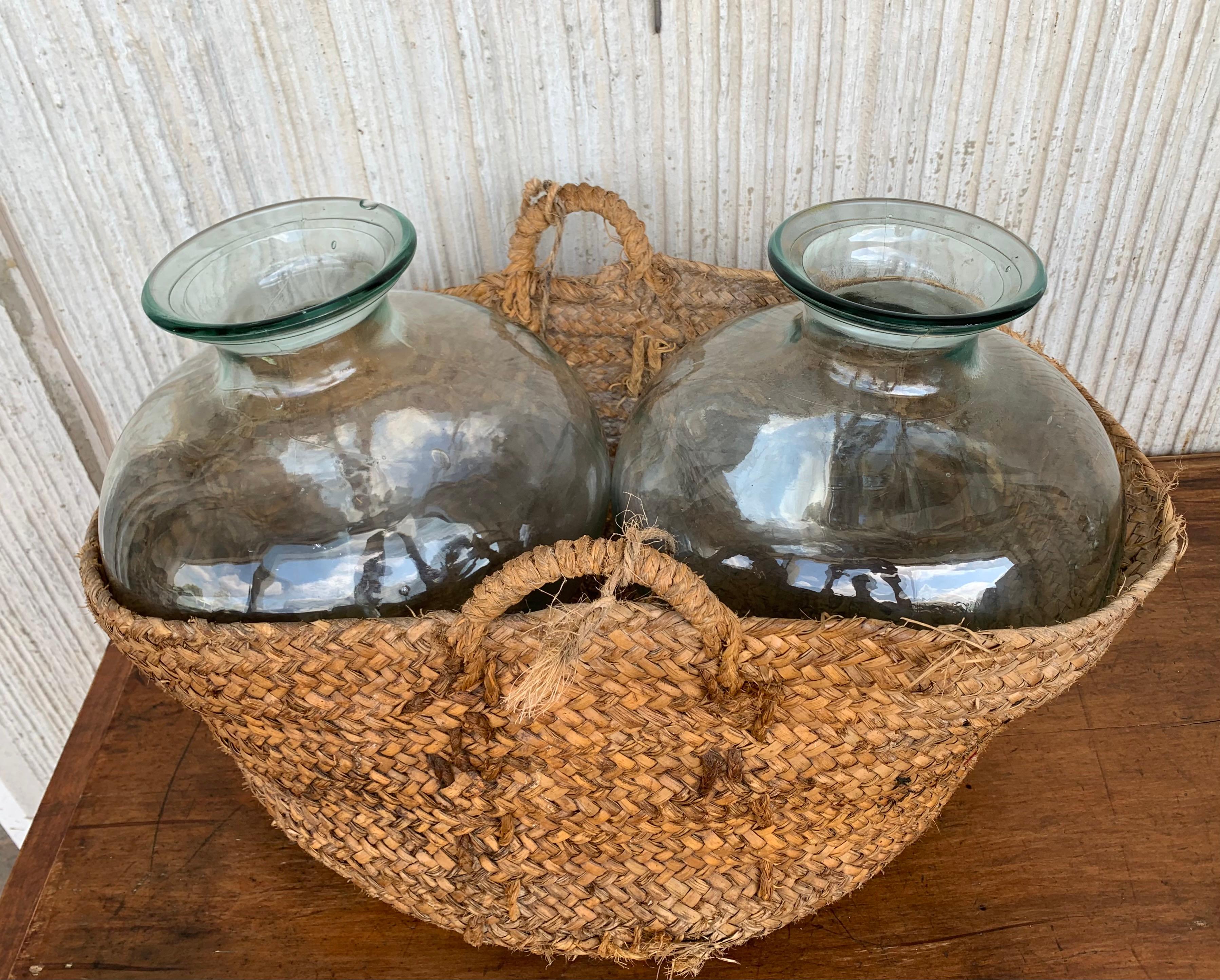 Spanish Colonial Set of 2 Green Glass French Demijohn Bottles with Woven Esparto Basket For Sale