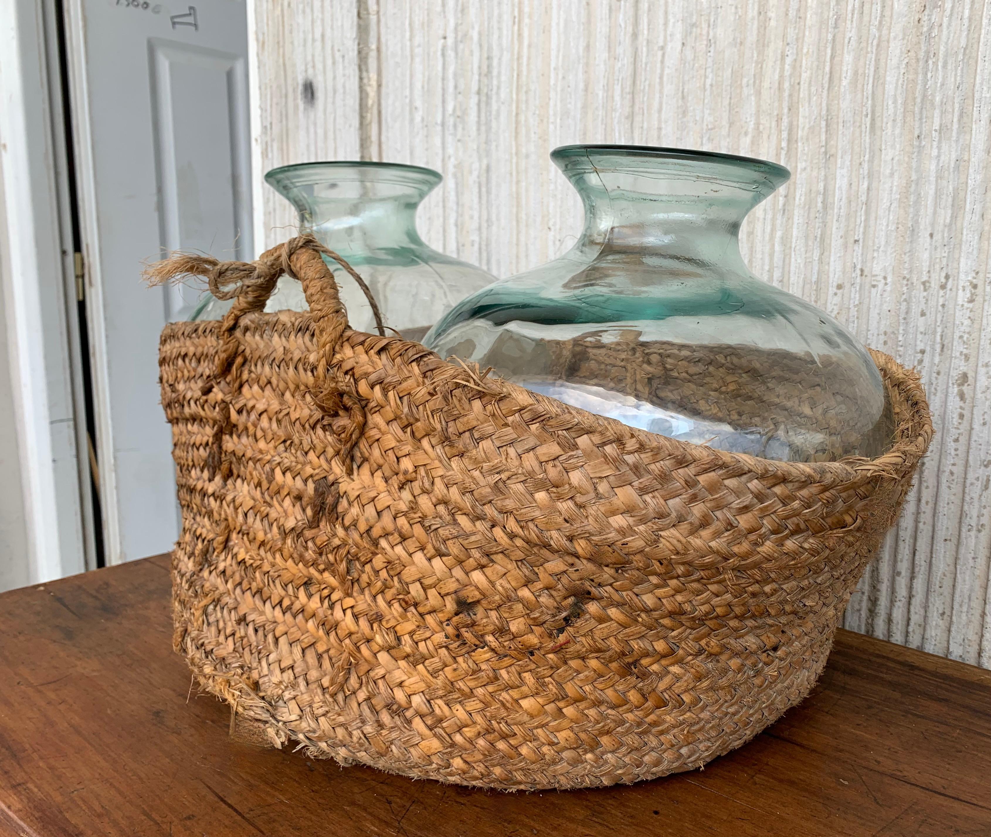 Spanish Set of 2 Green Glass French Demijohn Bottles with Woven Esparto Basket For Sale