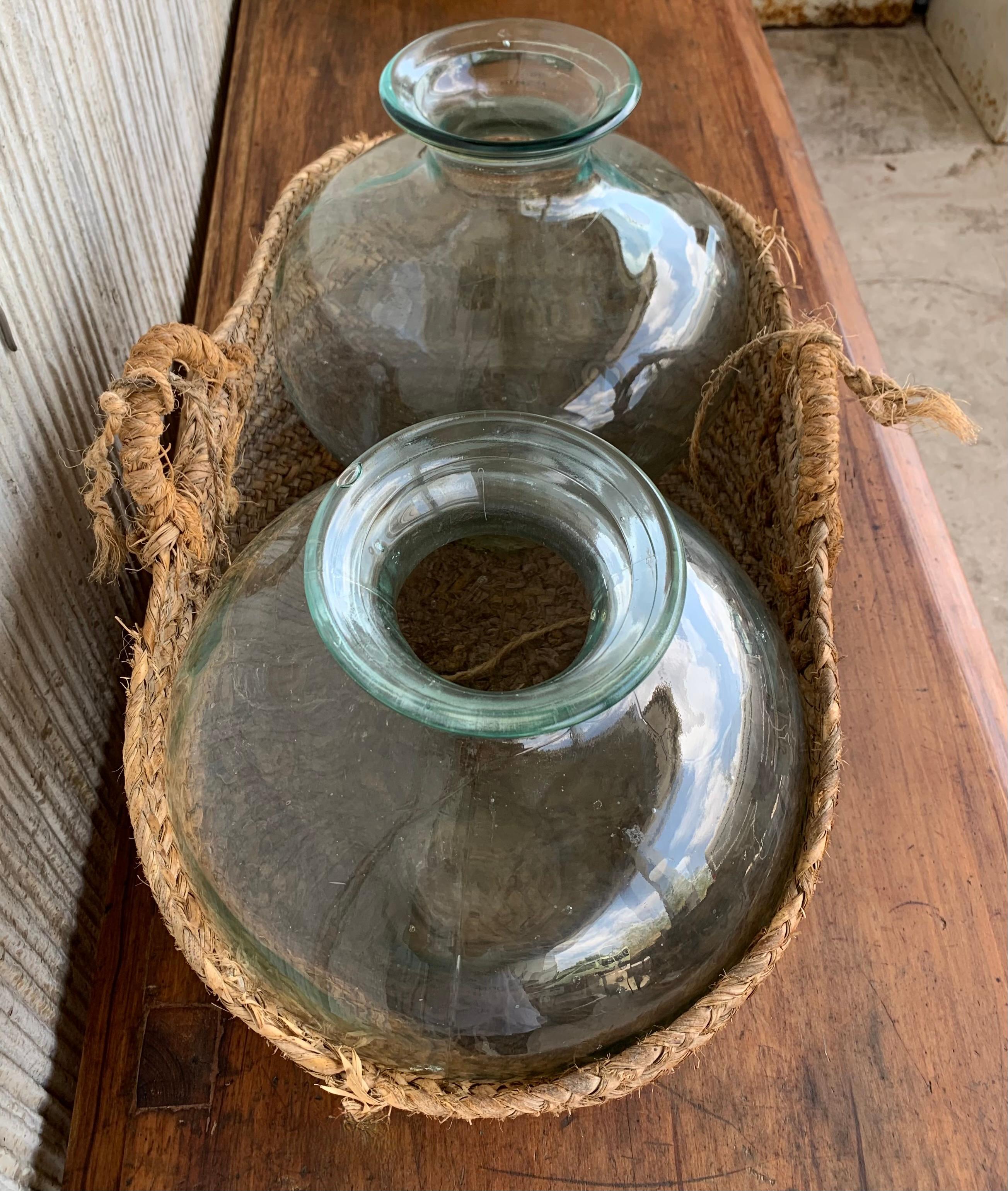 Set of 2 Green Glass French Demijohn Bottles with Woven Esparto Basket In Good Condition For Sale In Miami, FL