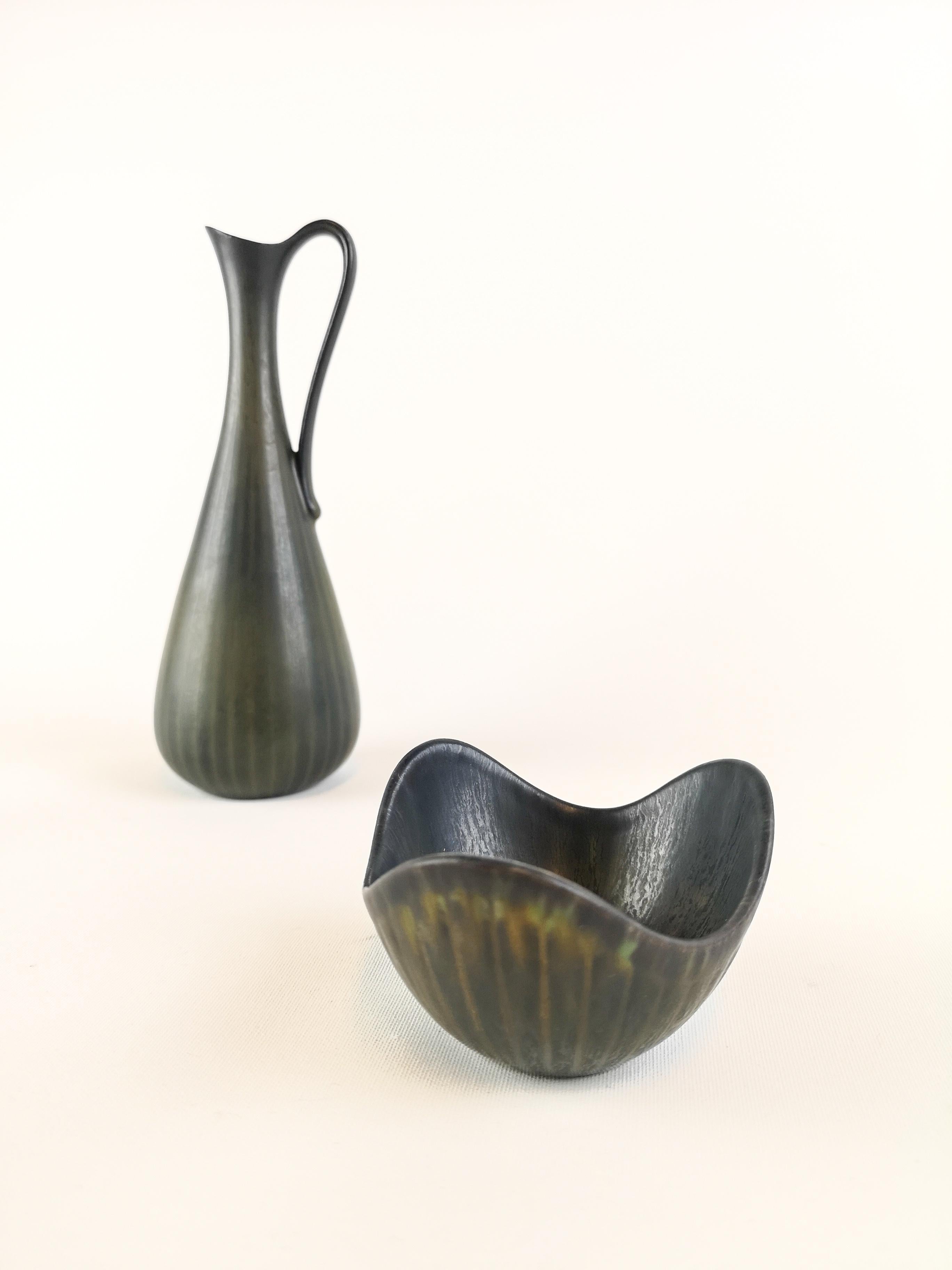 Two wonderful pieces made in Sweden during the 1950s at Rörstrand factory and designed by Gunnar Nylund.

The vase matches the bowl and gives a clean and modern look. The vase and bowl are nicely sculptured and have a nice glaze.

Good