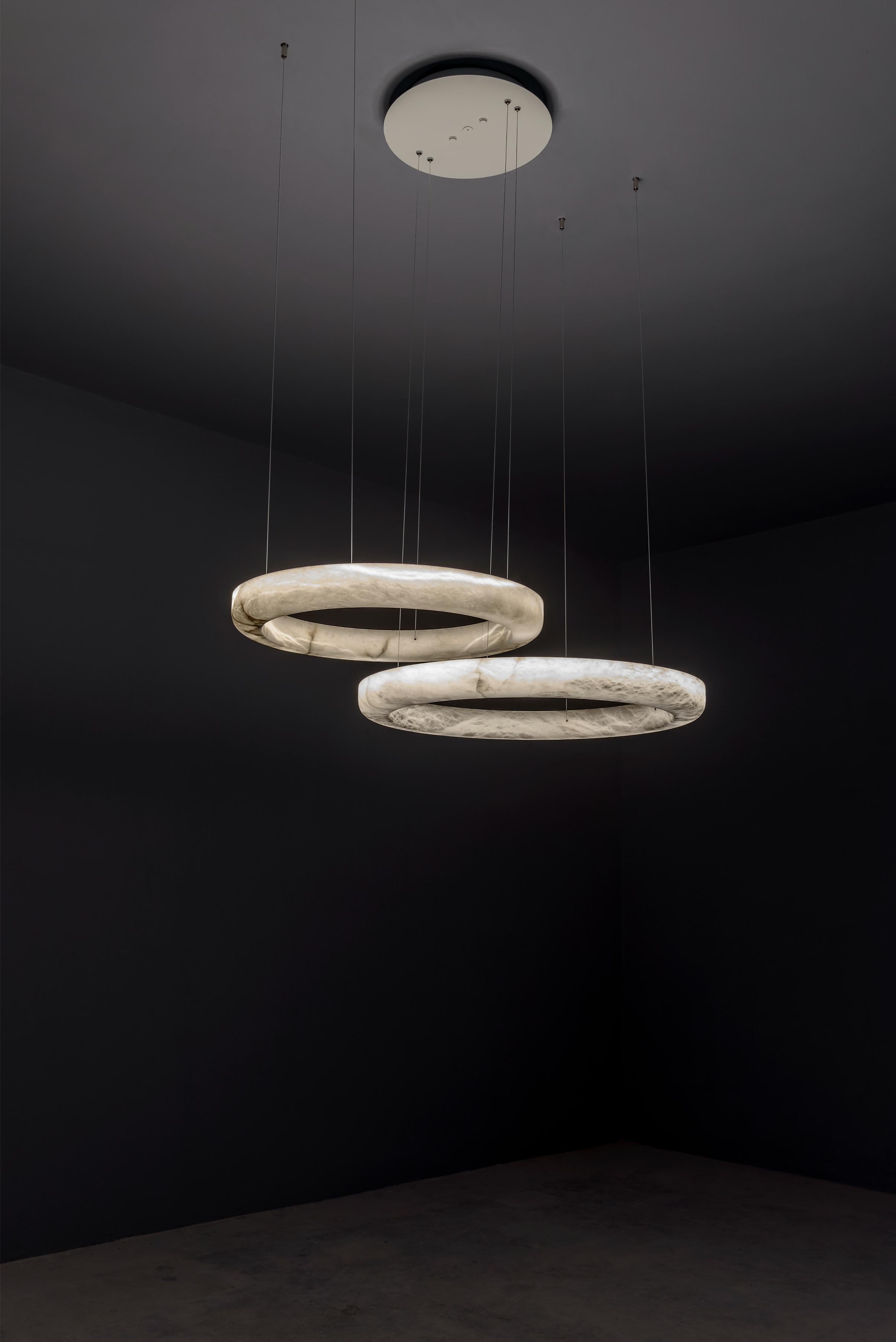 Set aus 2 Halos-Pendelleuchten von United Alabaster
Abmessungen: T 120 x H 150 cm (höhenverstellbar)
MATERIALIEN: Alabaster

Halo mit einer minimalistischen Struktur, vollständig beleuchtet, um alle Details jedes einzelnen Stücks zu schätzen.