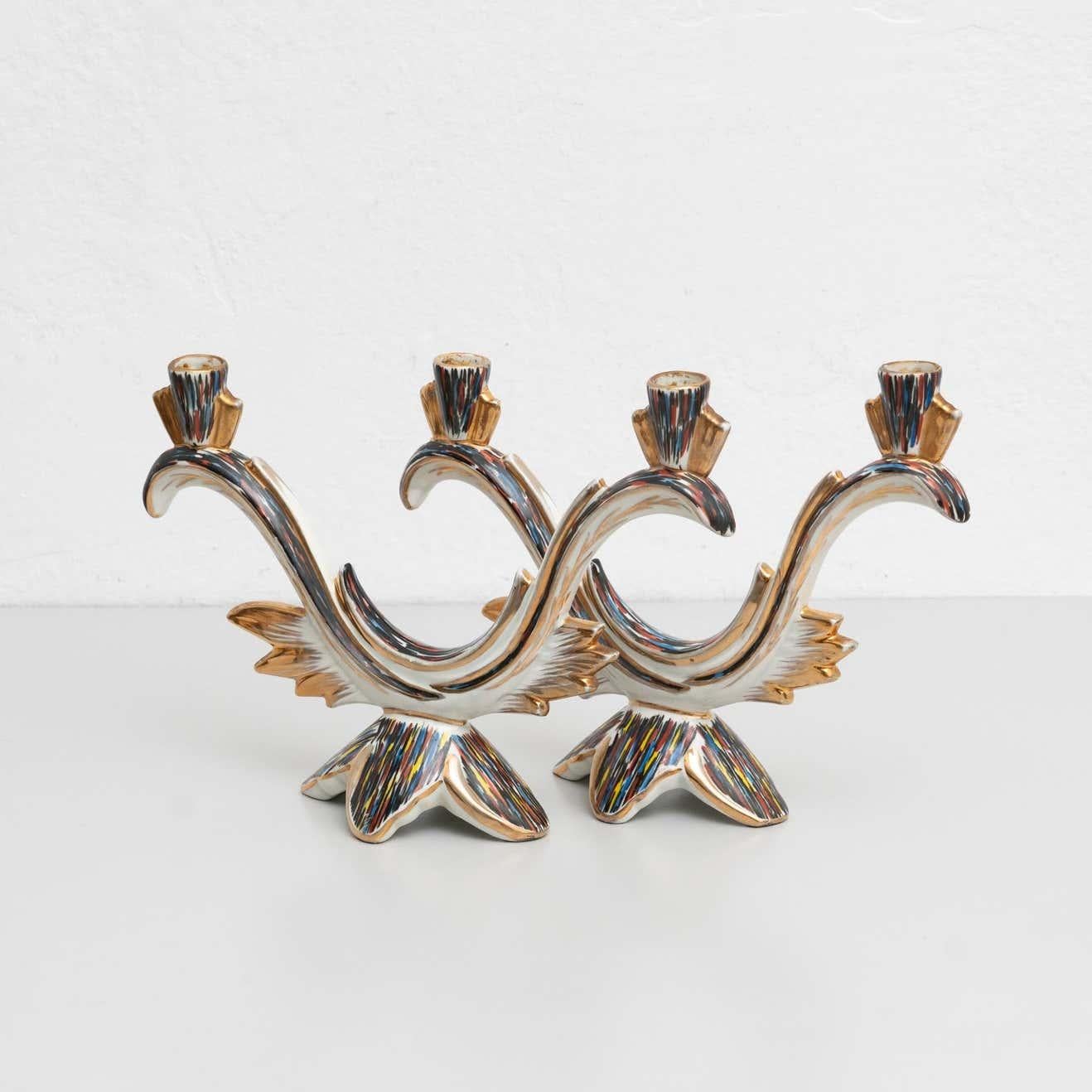 Set of 2 hand painted ceramic candle holders, circa 1940

By unknown manufacturer. Spain.

In original condition, with minor wear consistent with age and use, preserving a beautiful patina.

Materials:
Ceramic.
   