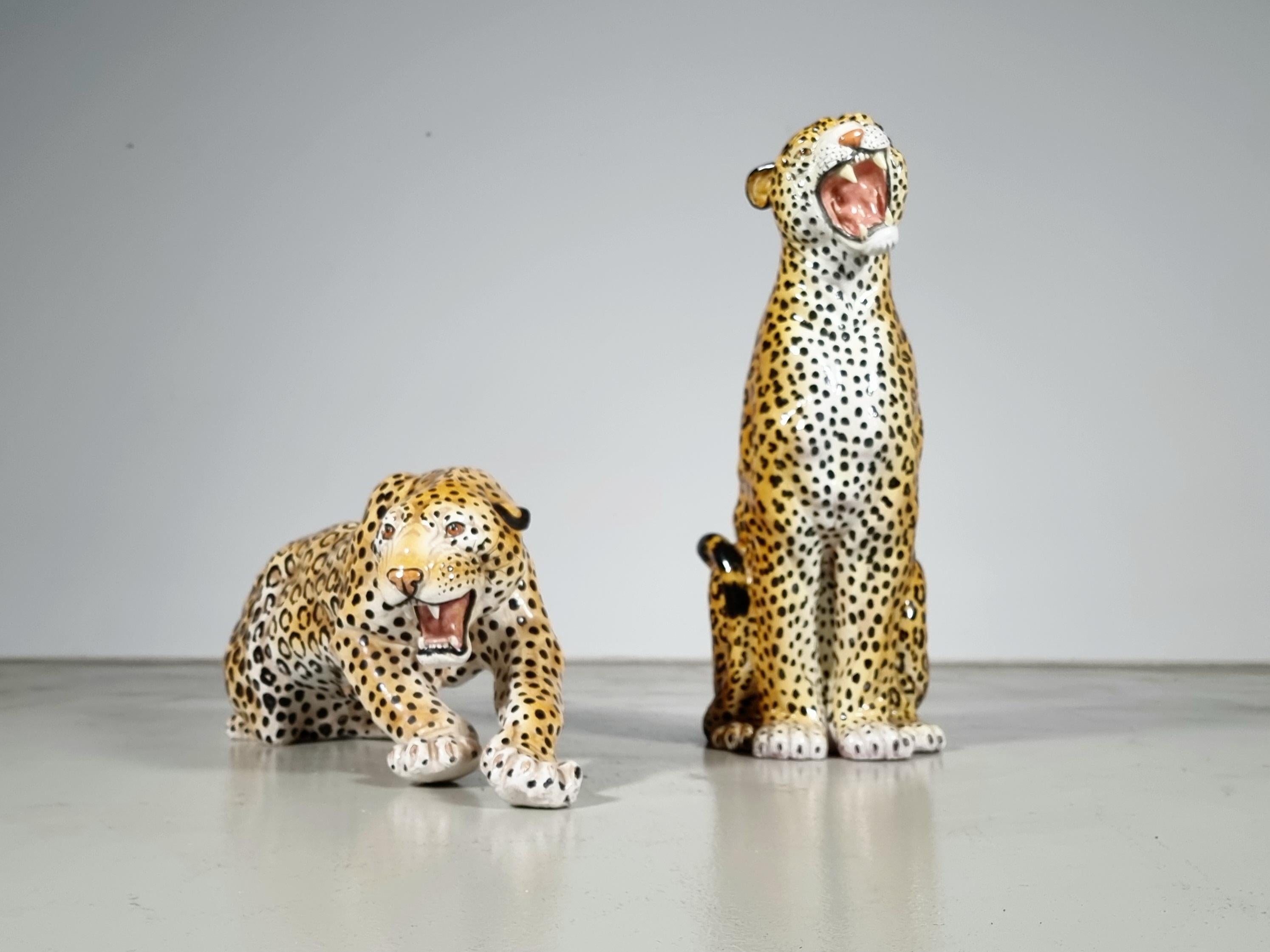 Unique pair of vintage very large hand-painted ceramic seated and lying leopard sculptures, Italy,  1960s,  Hollywood Regency style.

Very eclectic and decorative pieces that will make a statement.
Handmade in Italy, painted by hand, and then