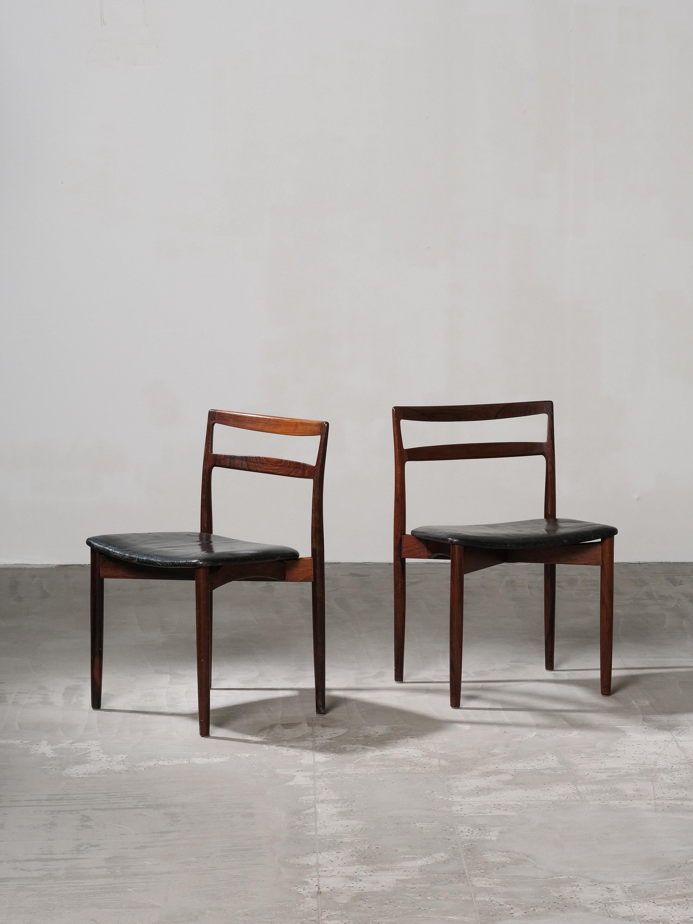 Fantastic pair of two dining chairs model 61 designed by Harry Østergaard and manufactured by Randers Mobelfabrik, Denmark, 1960s. The chairs have very nice characteristic, typical Danish modern features. The beautiful rosewood with dark flames in