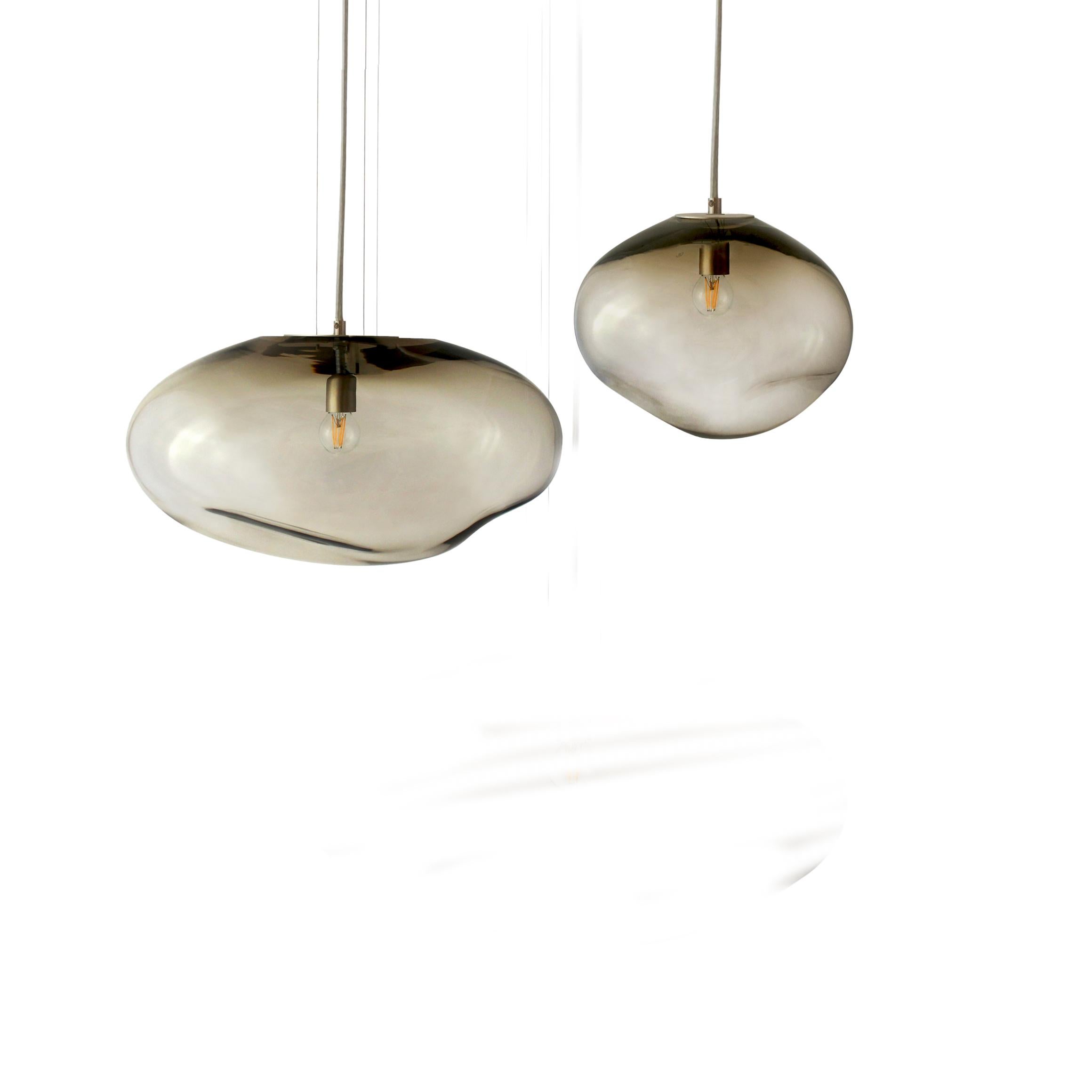 Set of 2 Haumea Amorph silver smoke M/L pendants by Eloa.
No UL listed 
Material: glass, steel, silver, LED bulb
Dimensions: D27 x W39 x H30/ D30 x W32 x H27 cm
Also available in different colours and dimensions.

All our lamps can be wired