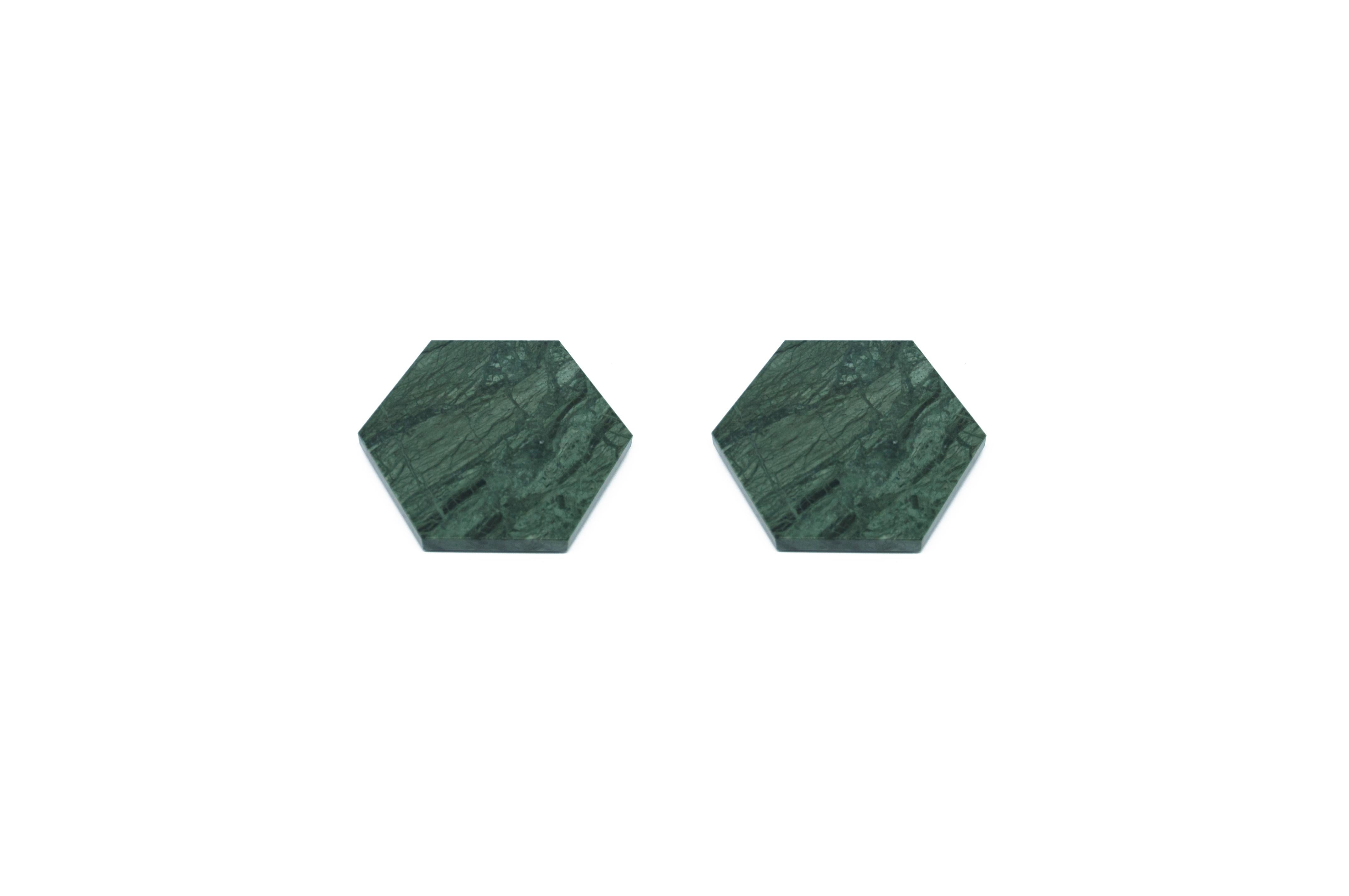 Set of 2 hexagonal shape green Guatemala marble coasters with cork underneath. Each piece is in a way unique (every marble block is different in veins and shades) and handmade by Italian artisans specialized over generations in processing marble.