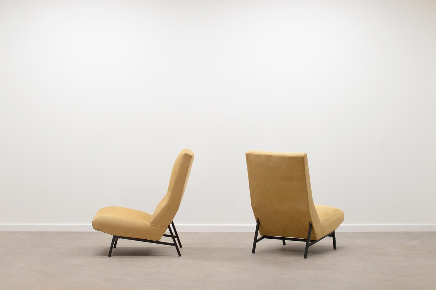 Set of 2 high back lounge chairs, 60s France. Low black metal base and reupholsteren in a suede look fabric with a gold beige color. In very good condition. Sold as a set. 

