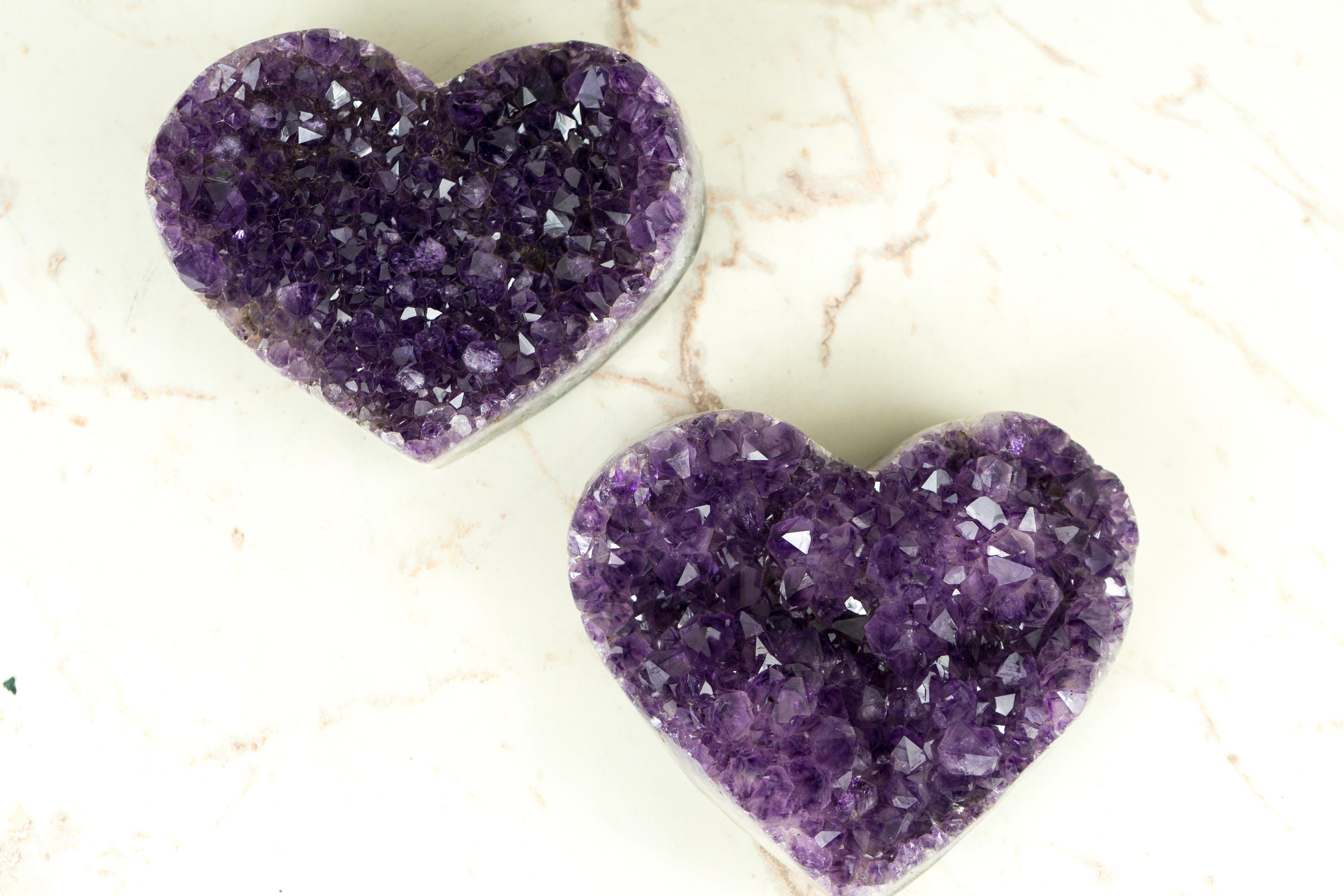 We selected this set of Amethyst Hearts with high quality, deep color, and the overall beauty and shine of the hearts in mind. With each heart having its particular rare characteristics such as Amethyst Flowers, Golden Goethite inclusions, and