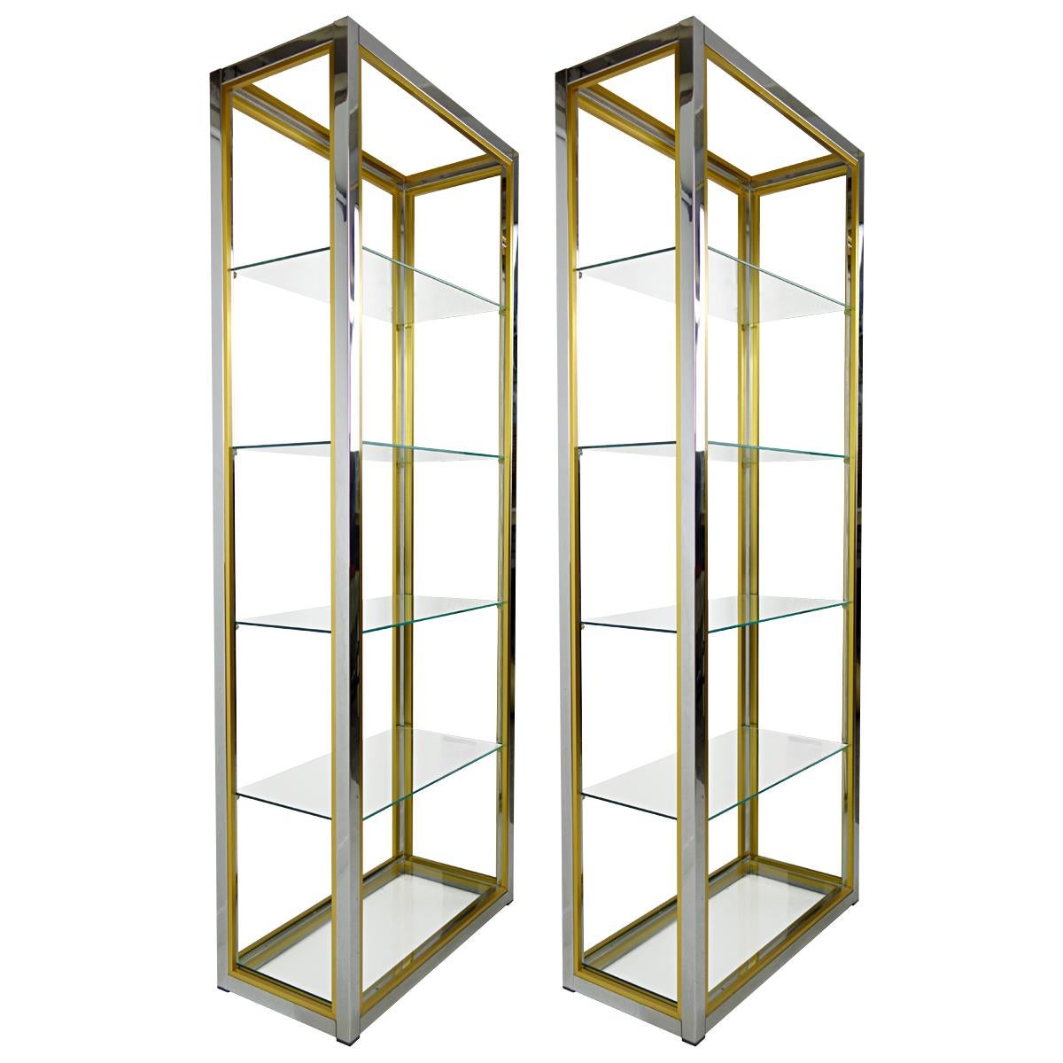 Set of two Hollywood Regency étagères in chrome, brass and glass created by Renato Zevi.
These étagères are a sleek mix of shiny chrome, brass and black smoke glass making for great displays for your beloved collections. Each contains five glass