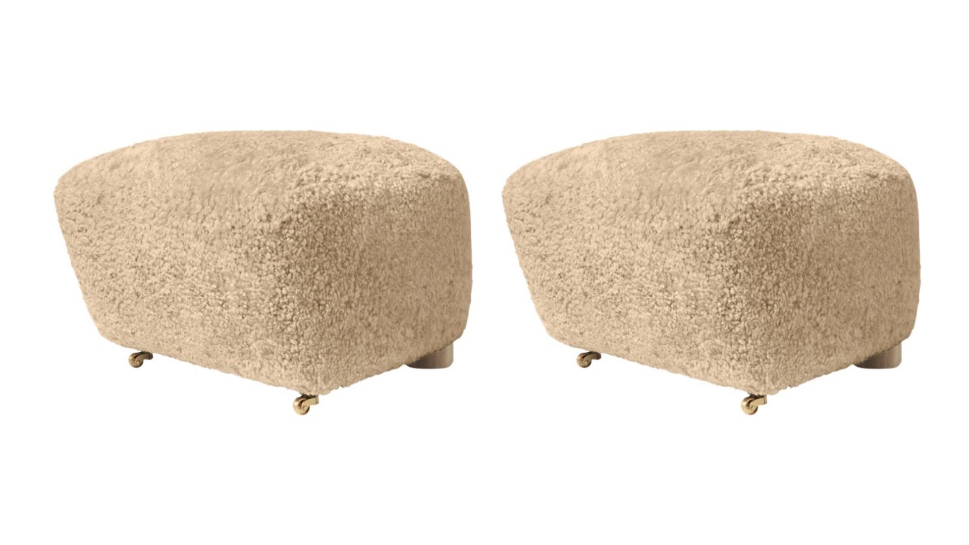 Set of 2 honey natural oak sheepskin the tired man footstools by Lassen.
Dimensions: W 55 x D 53 x H 36 cm 
Materials: Sheepskin

Flemming Lassen designed the overstuffed easy chair, The Tired Man, for The Copenhagen Cabinetmakers’ Guild