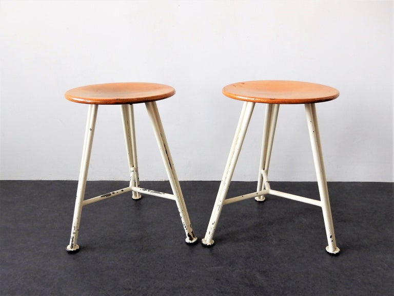 This is a very nice set of Industrial stools. The previous owner let us know they are from a former textile factory in The Netherlands. Very likely from the 1950s. They have a (white painted) steel frame with wooden seat. The stools are in a good