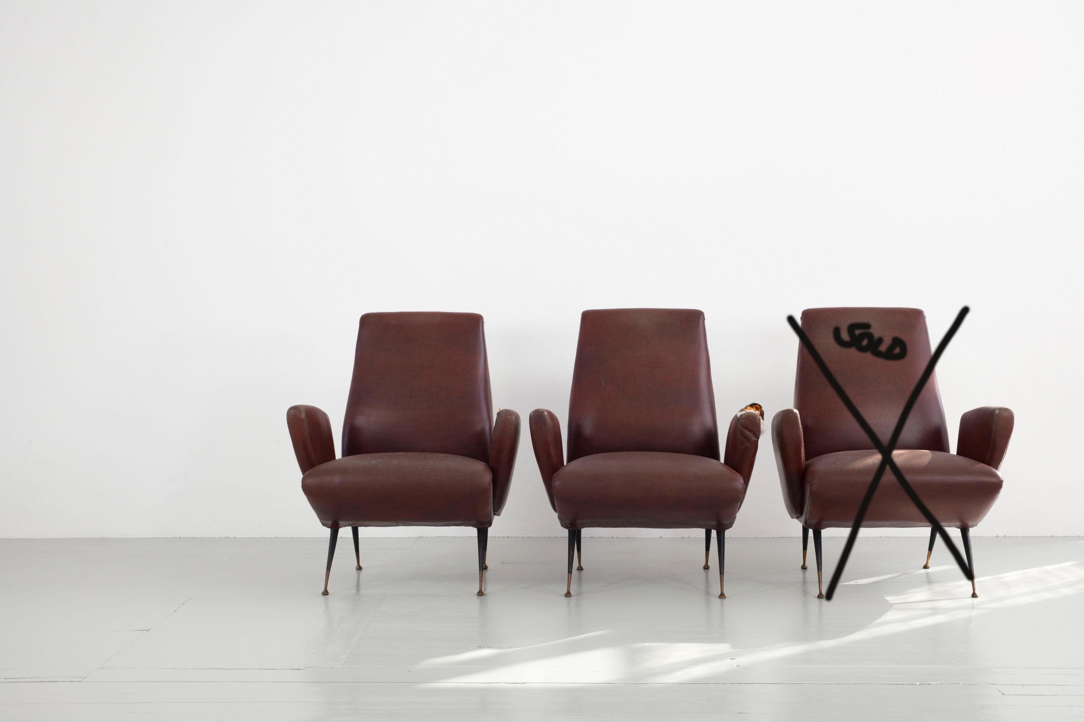 Zwei Sessel, entworfen von Nino Zondada, Italien, 1950er Jahre. Die Sessel sind mit Vinylleder gepolstert und haben klassische Metallfüße mit Messingelementen für einen zweifarbigen Look. Die beiden Stücke, die ich brauche, müssen neu gepolstert