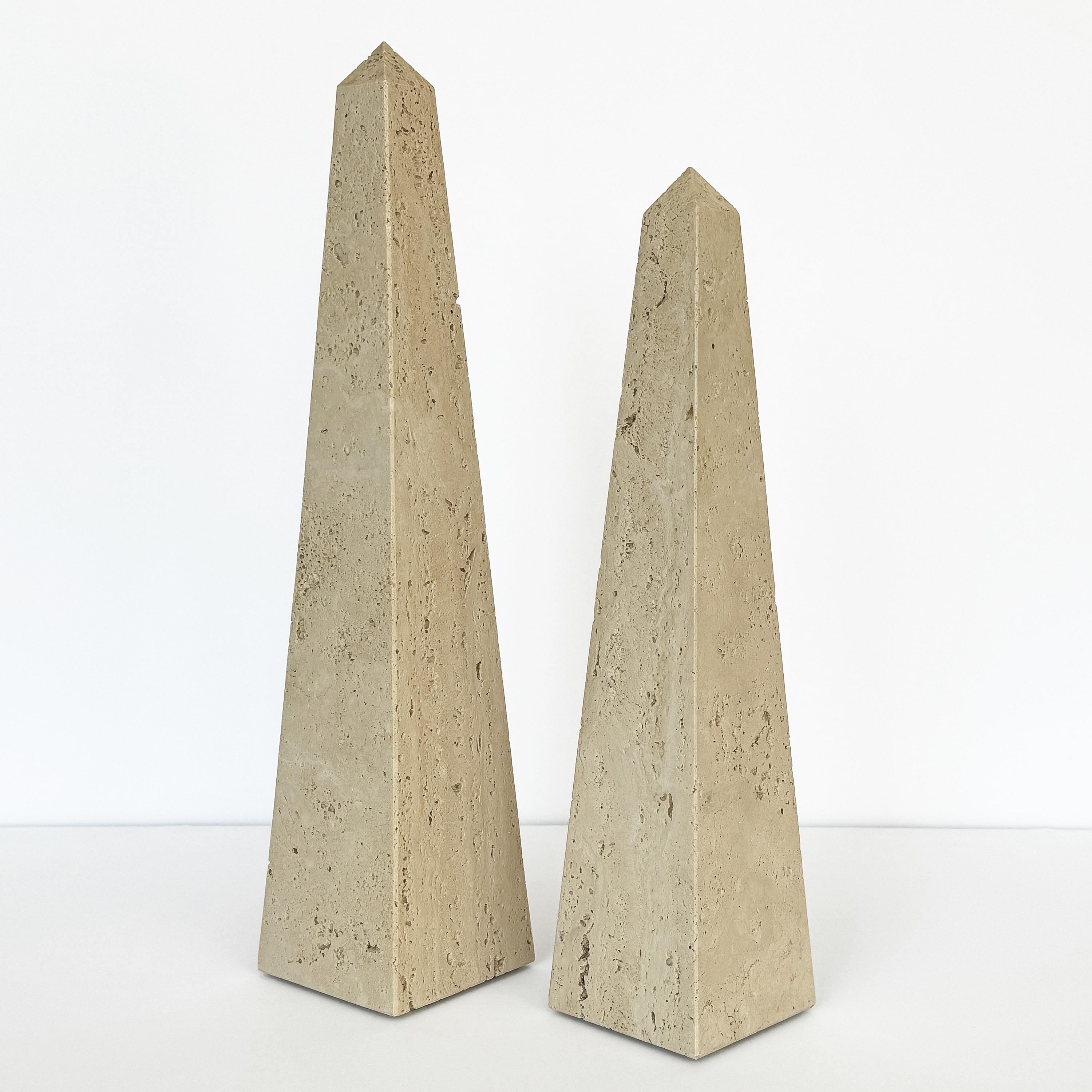 This set of two large Italian solid travertine stone obelisk sculptures from the 1970s is a striking example of timeless elegance and refined design, reminiscent of the work of Fratelli Mannelli. Crafted from beautiful unfilled travertine, these
