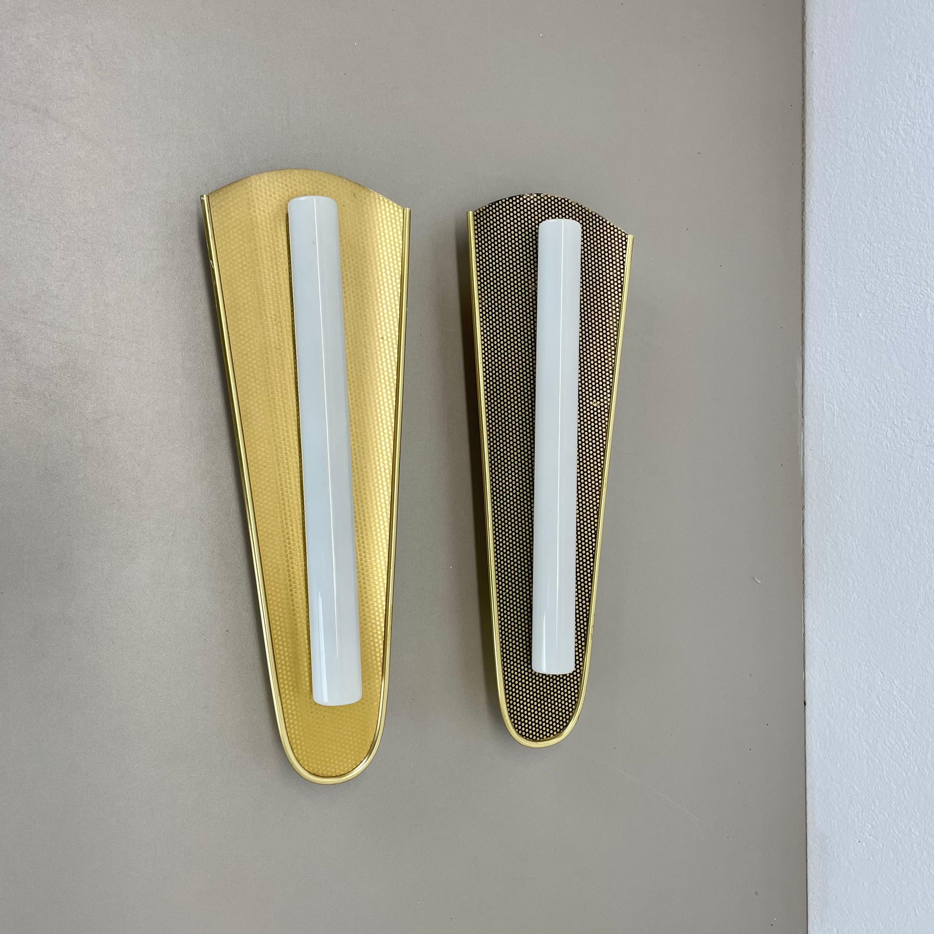 Article:

set of 2
wall lights


Origin:

Germany


AGE:

1950s




Description:

Original vintage wall light set designed and produced in Germany in the 1950s. The lights are aluminum metal in gold tone finish with a nice abstract 