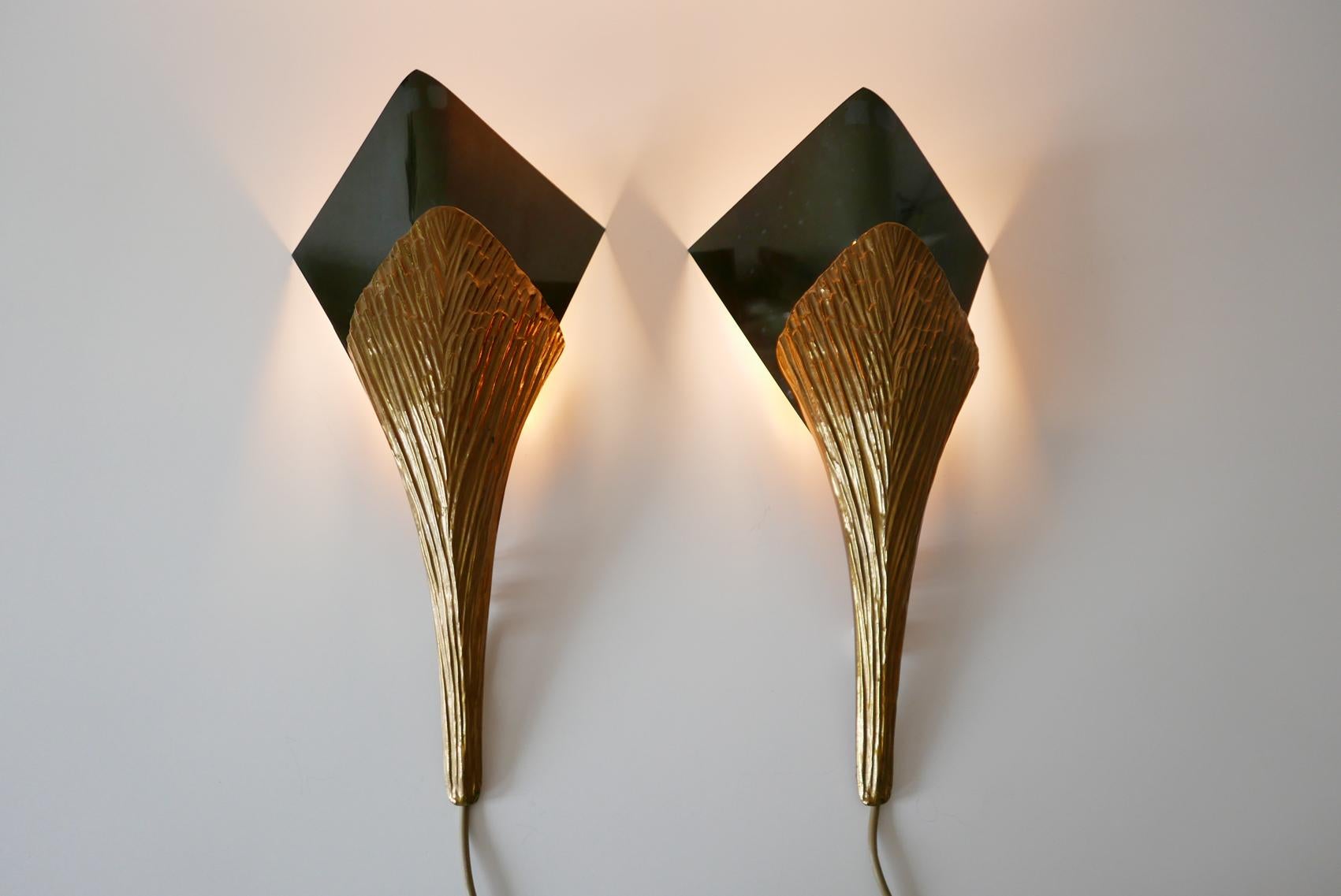 Set of two impressive Nefertiti wall lamps / sconces in bronze. Designed by Chrystiane Charles. Handmade by Charles Paris.

Executed in bronze and brass, each lamp needs 1 x E27 Edison screw fit bulb. Delivery without bulbs. It runs both on 110 /