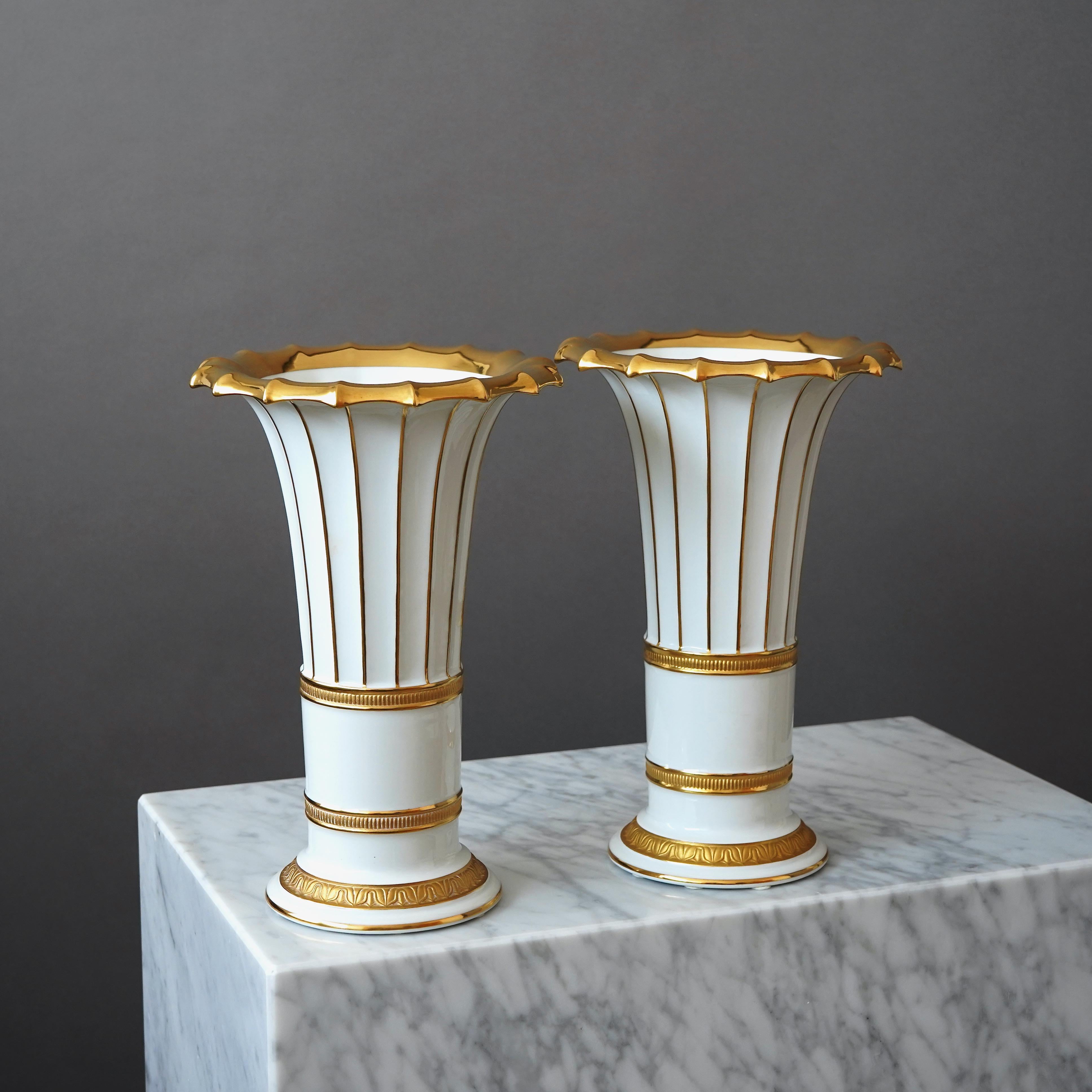 A pair of very elegant and well crafted Royal Copenhagen vases with gilded hand painted details.
Designed by Gustav Friedrich Hetsch. Made by ROYAL COPENHAGEN in Denmark, 1957.

Excellent condition. Makers marks on base of vases.