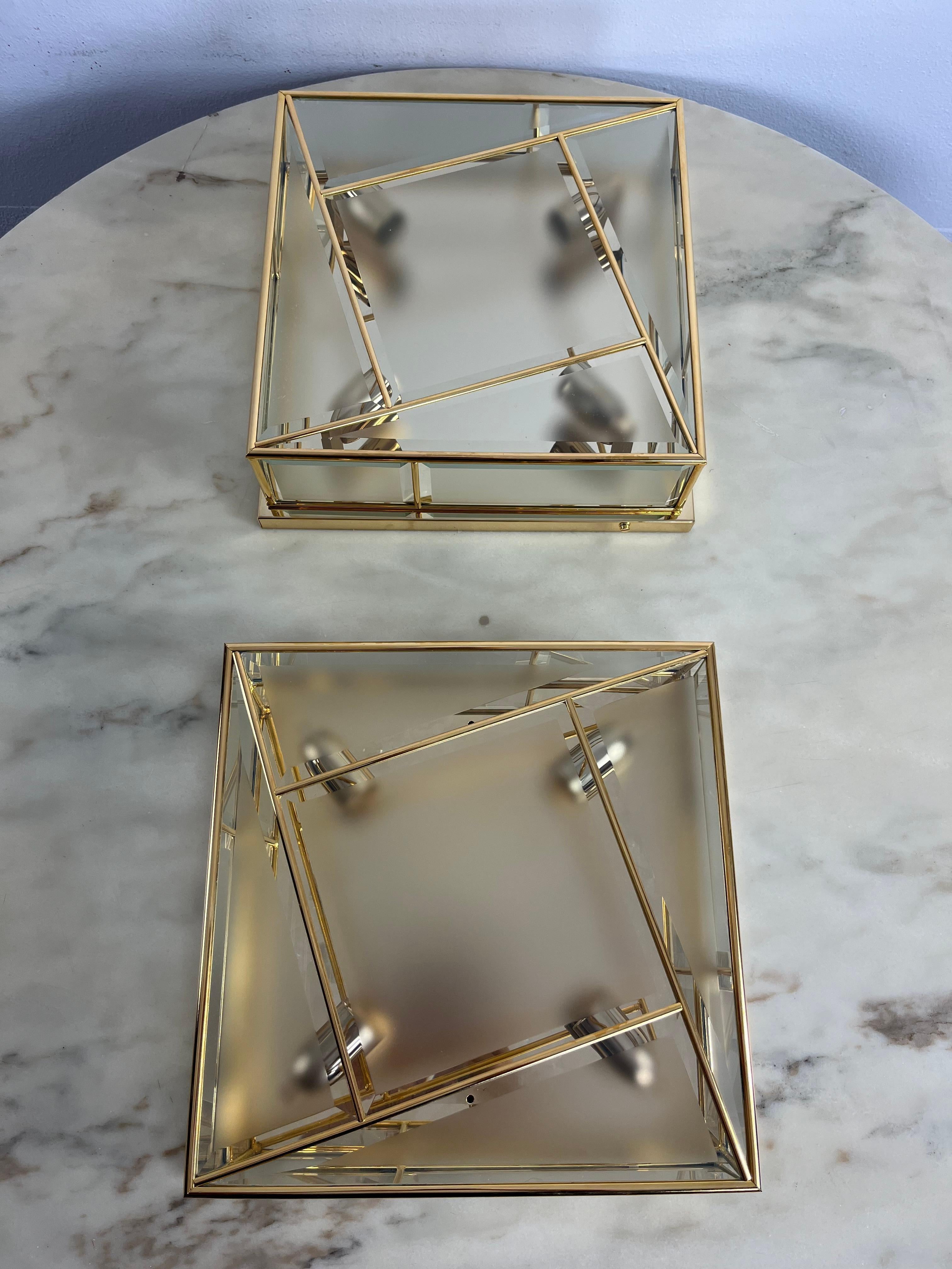 Set of 2 large square 4-light ceiling lights 1980s, never used
Golden metal and brass structure, frosted glass.
Good condition, e14 lamps.
Found in the warehouse of a famous furniture shop in my city, Palermo.