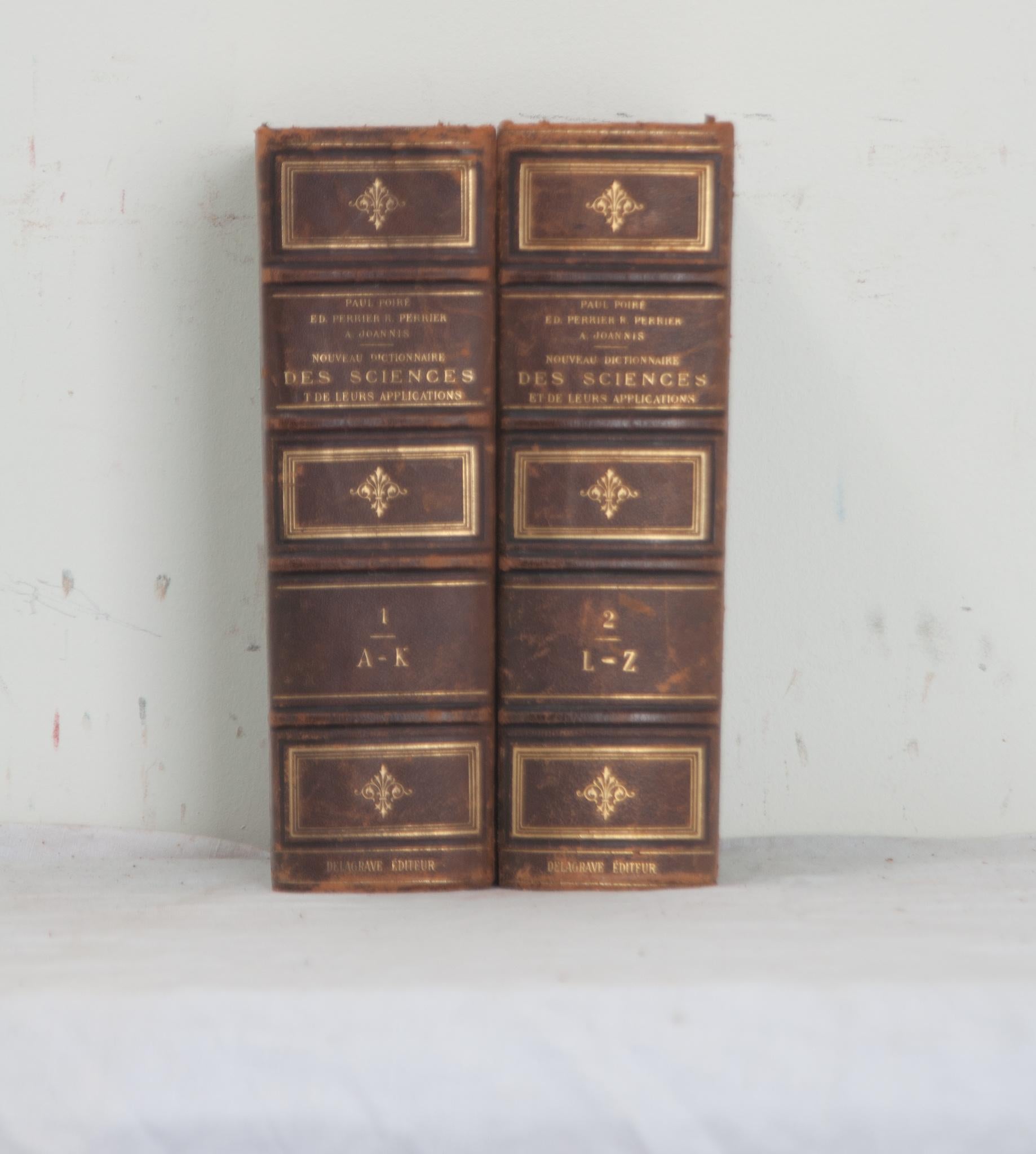 A French pair of Nouveau Dictionnaire Des Sciences books by Paul Poiré. The collection of books is leather bound with gold lettering stating the author, title, and respective volume. Written in 1888, the set is a science dictionary with terms and