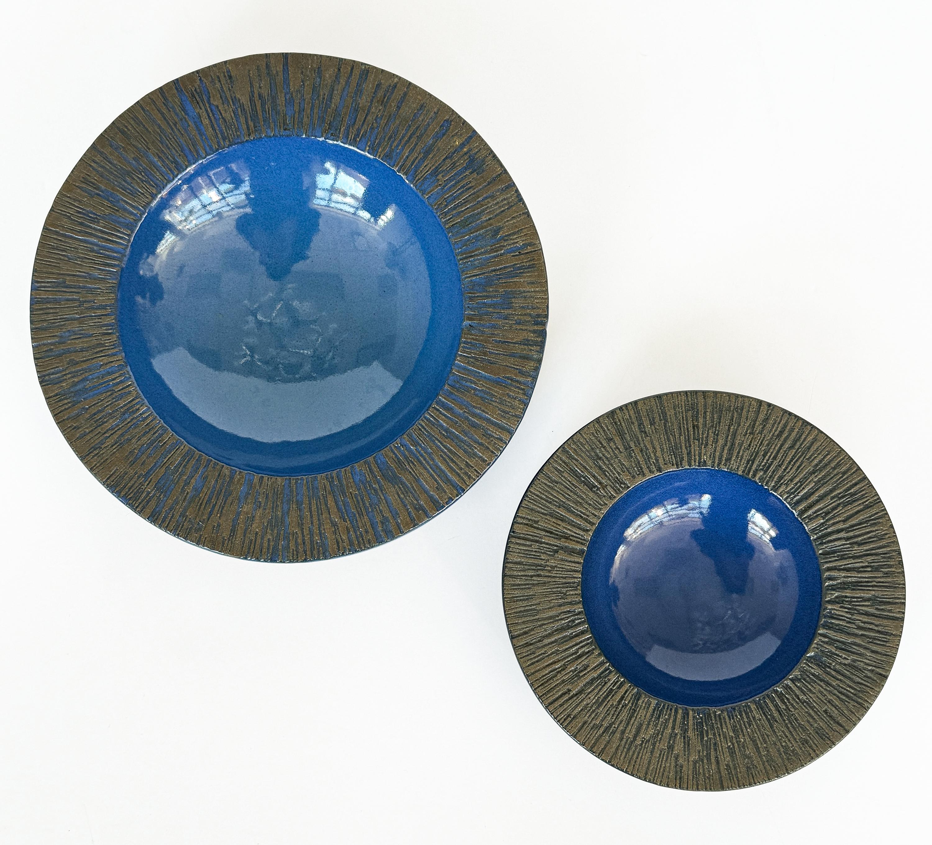 Introducing a captivating set of two Modernist low bowls, designed by Lee Rosen for Design Technics in the spirited 1960s. These vide poche, or catchall bowls, are a sublime blend of function and aesthetic delight, embodying the essence of