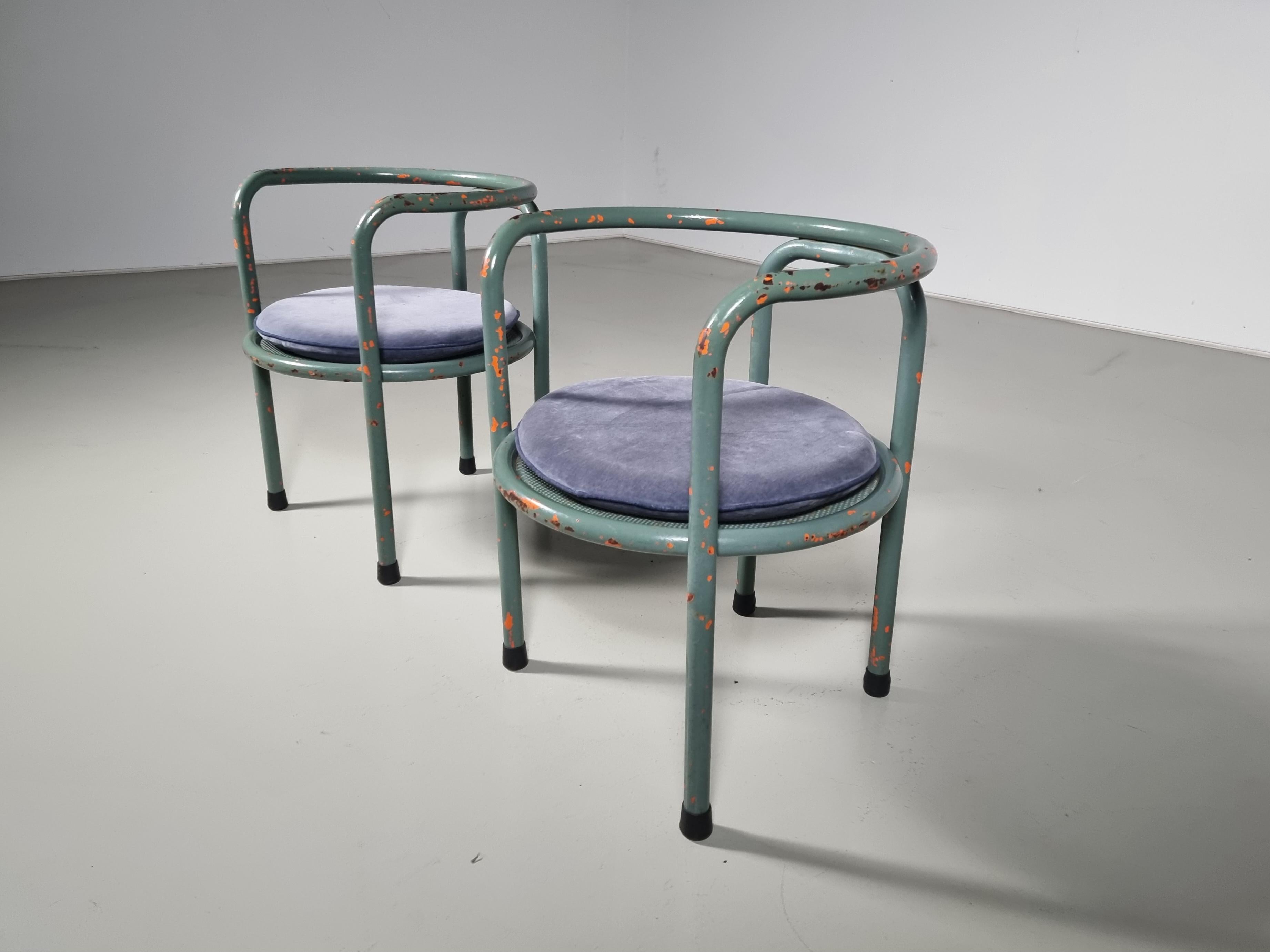 A set of 2 lacquered metal Locus Solus chairs by Gae Aulenti for Poltronova, 1964.
The round seat is perforated sheet metal. The structure, which forms the backrest, armrests, and legs, is in tubular steel. The design was initially meant for
