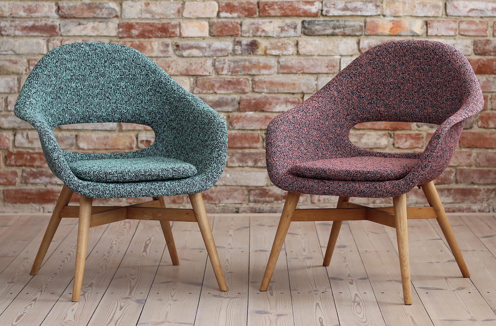 This set of 2 lounge chairs was designed in 1950s by Miroslav Navrátil in Czech Republic. It features a fiberglass seating shell and a wooden base. The piece has been renovated and reupholstered with high-quality fabric from latest collection of