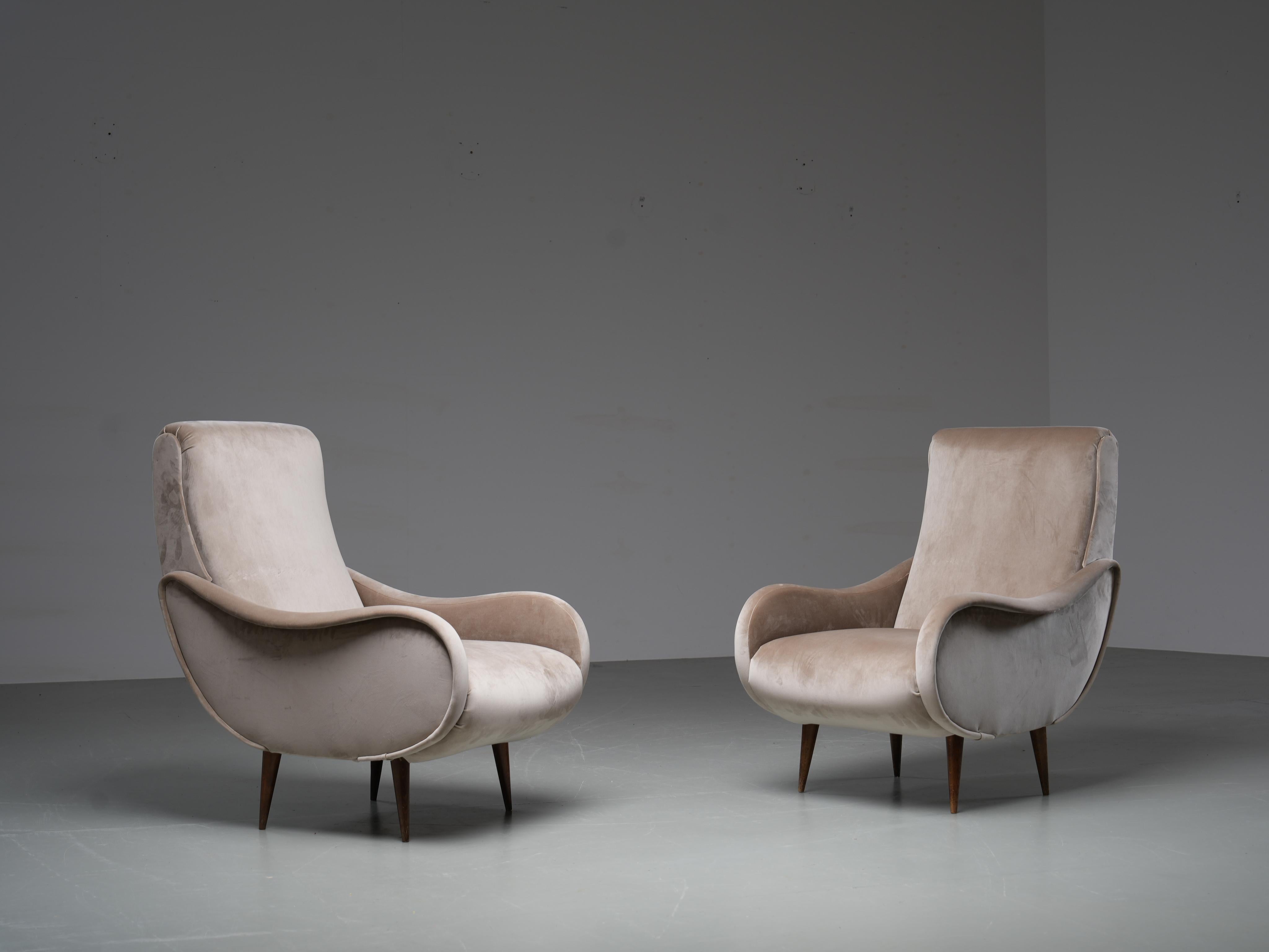 Beautiful pair of recently reupholstered lounge chairs in the style of Marco Zanuso's Ladychair. The velvet is very light brown and is as new and feels very soft. The oak tapered legs have beautiful patina and grain.

Some real Italian classical