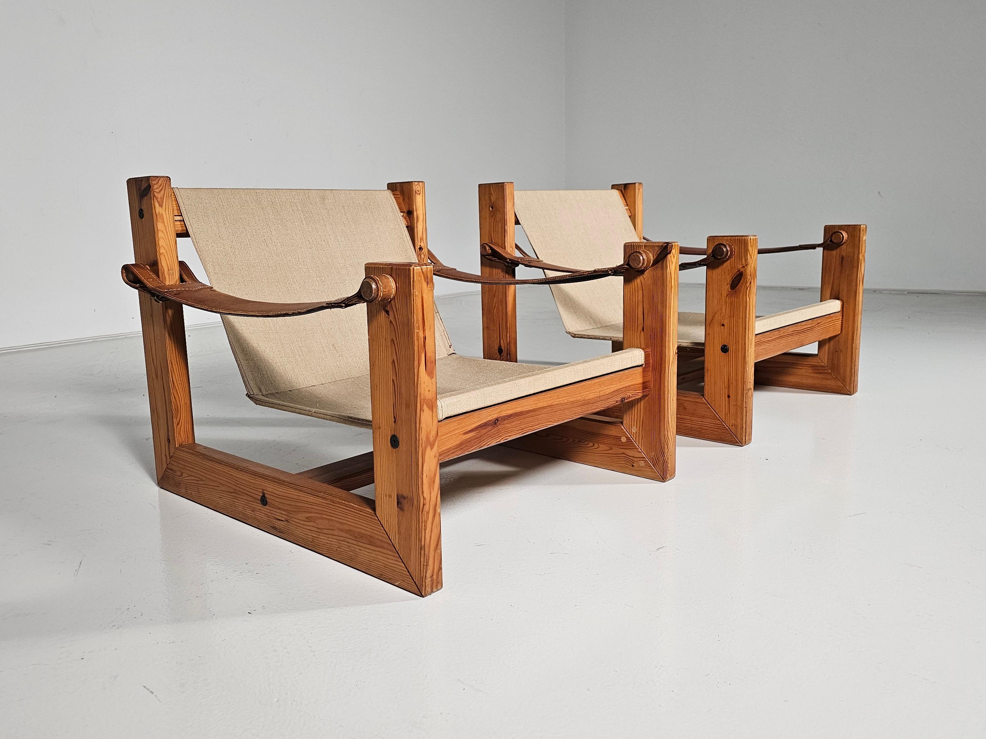 Lounge sling chairs, canvas, solid pine, The Netherlands, circa 1970s. 

Embrace comfort and style with these Ate van Apeldoorn inspired sling lounge chairs. Crafted from solid pine, canvas, and patinated leather armrests.  The perfect blend of