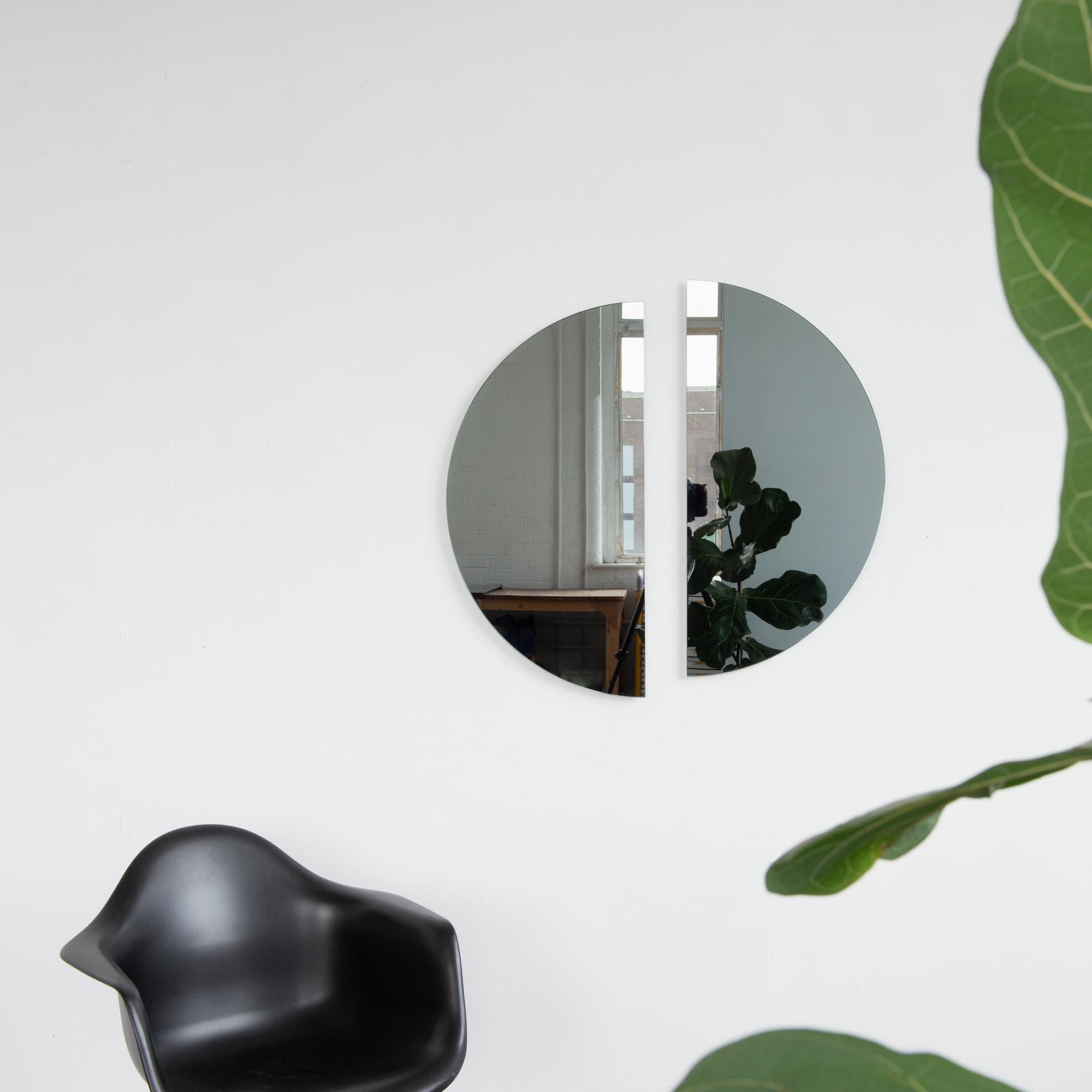 Set of two minimalist half-moon Luna™ black tinted frameless mirrors with a floating effect. Fitted with a quality hanging system for a flexible installation in 4 different directions. Designed and made in London, UK. 

Our mirrors are designed with