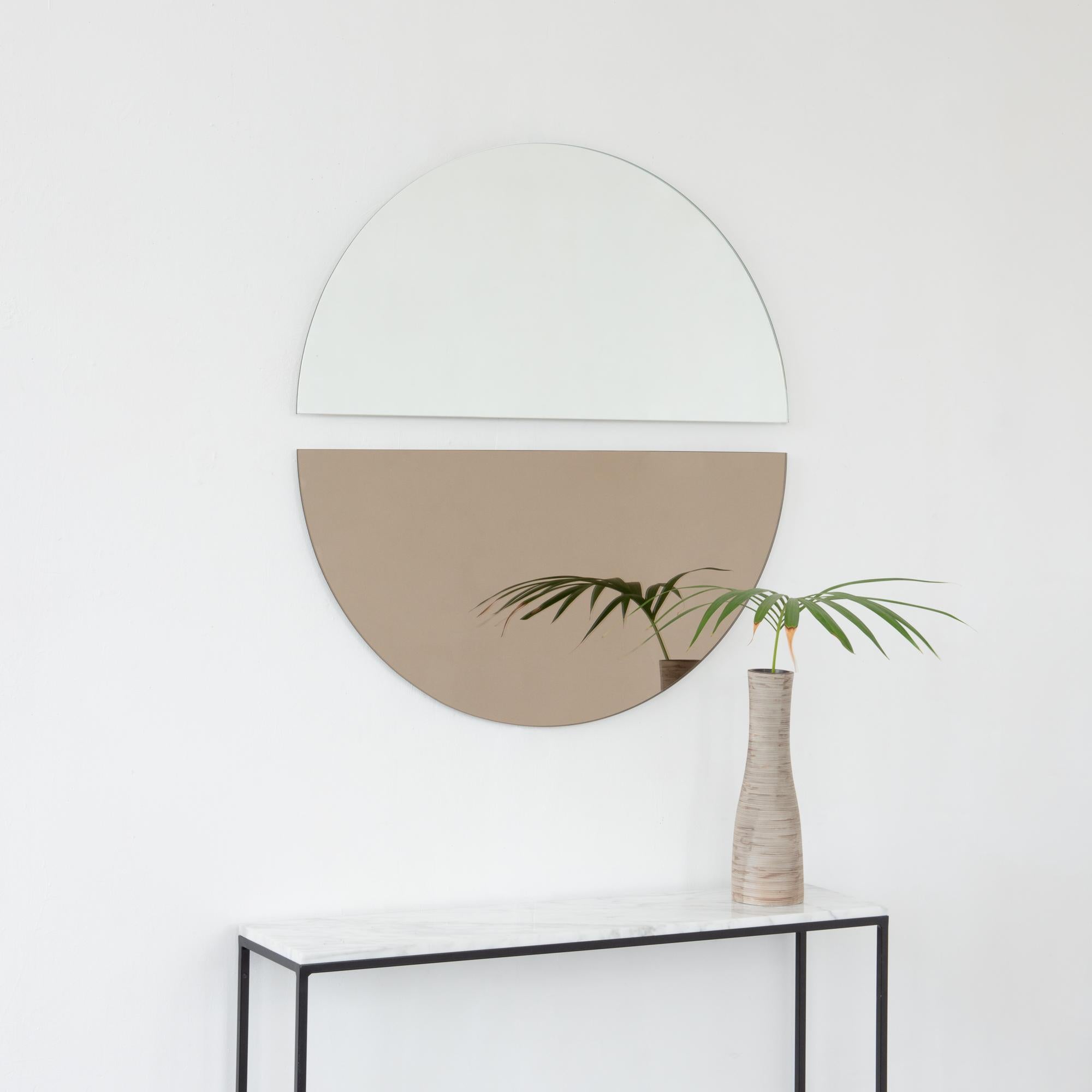 Set of two minimalist half-moon Luna™ standard silver + bronze tinted frameless mirrors with a floating effect. Fitted with a quality and ingenious hanging system for a flexible installation in 4 different directions. Designed and made in London,