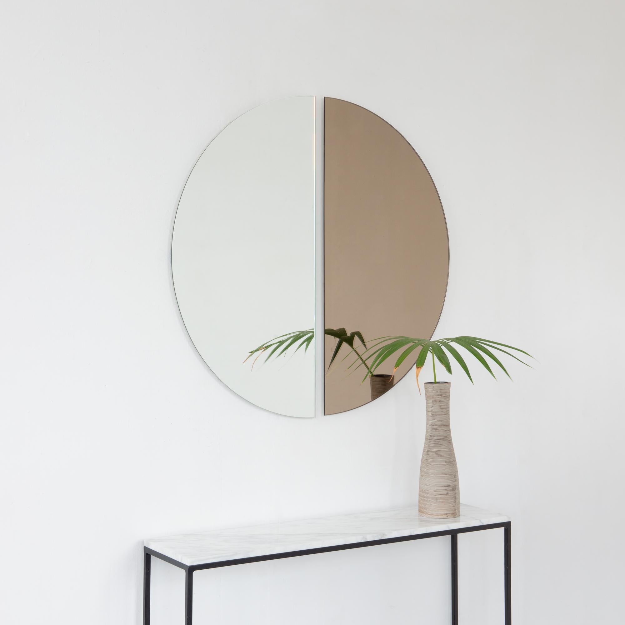 Set of two minimalist half-moon Luna™ standard silver + bronze tinted frameless mirrors with a floating effect. Fitted with a quality and ingenious hanging system for a flexible installation in 4 different directions. Designed and made in London,