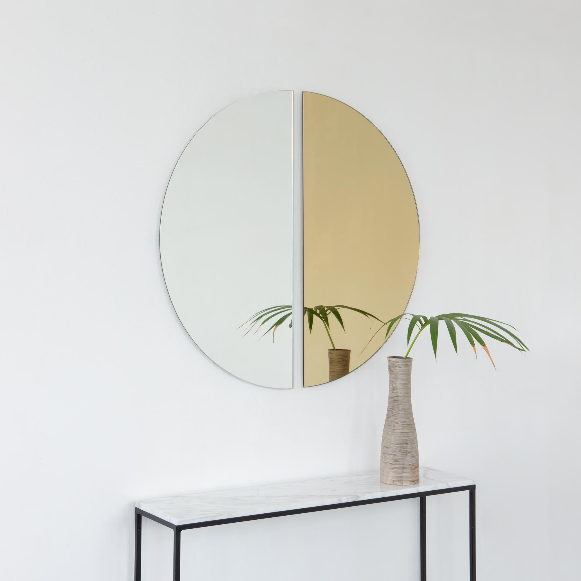 Set of two minimalist half-moon Luna™ standard silver + gold tinted frameless mirrors with a floating effect. Fitted with a quality hanging system for a flexible installation in 4 different directions. Designed and made in London, UK. 

Our mirrors
