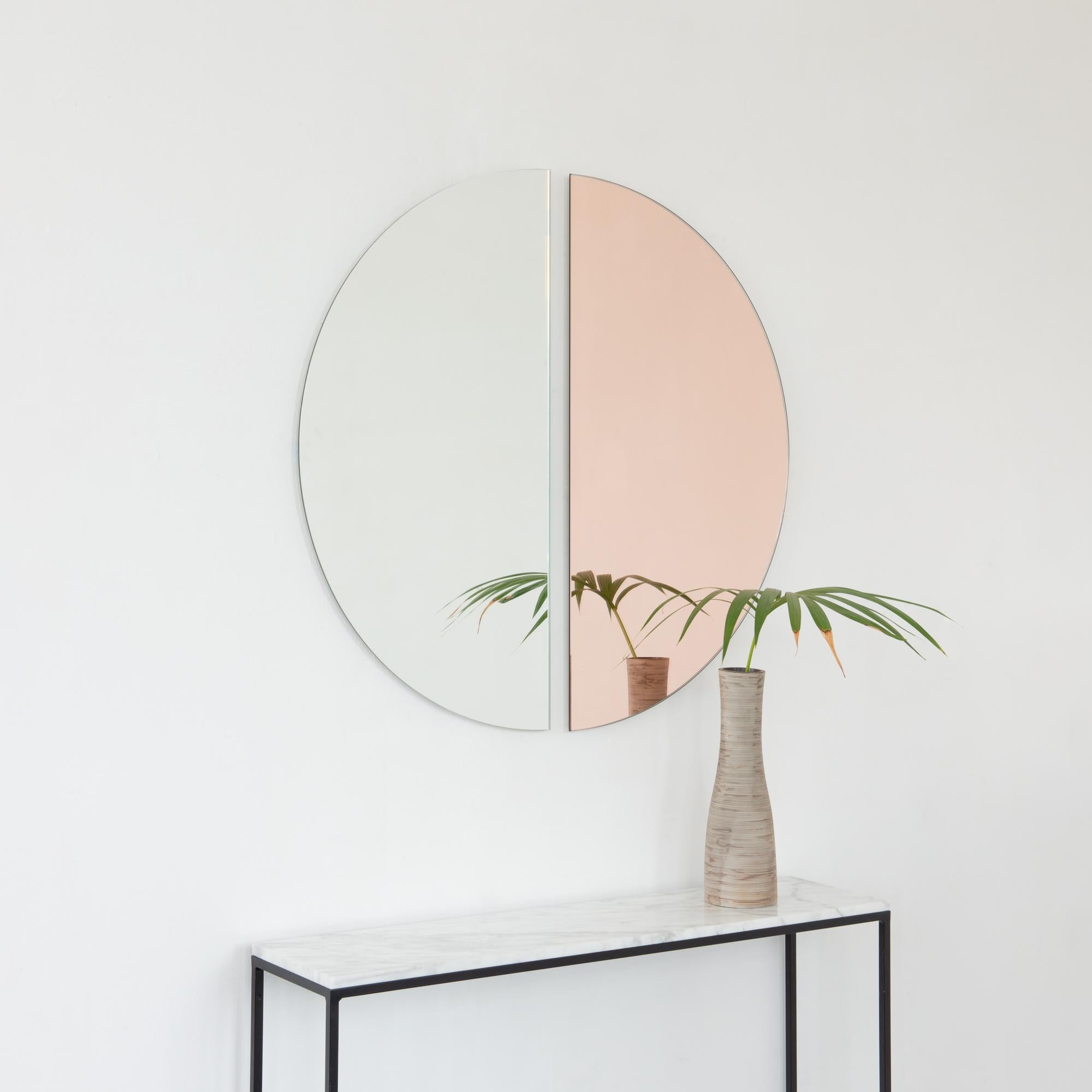 Set of two minimalist rose gold (peach) and standard silver Luna™ half-moon frameless mirrors with a floating effect. Fitted with a quality hanging system for a flexible installation in 4 different directions. Designed and made in London, UK. 

Our