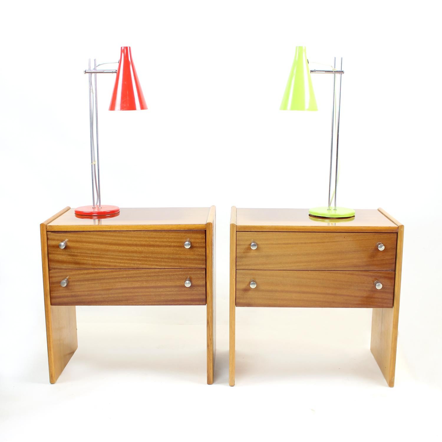 Beautiful vintage bedside tables produced in Czechoslovakia by UP Zavody in 1970s. Original label still partially attached on the back. The tables are made of ash wood construction and sides with the mahogany veneer on top board and front side of