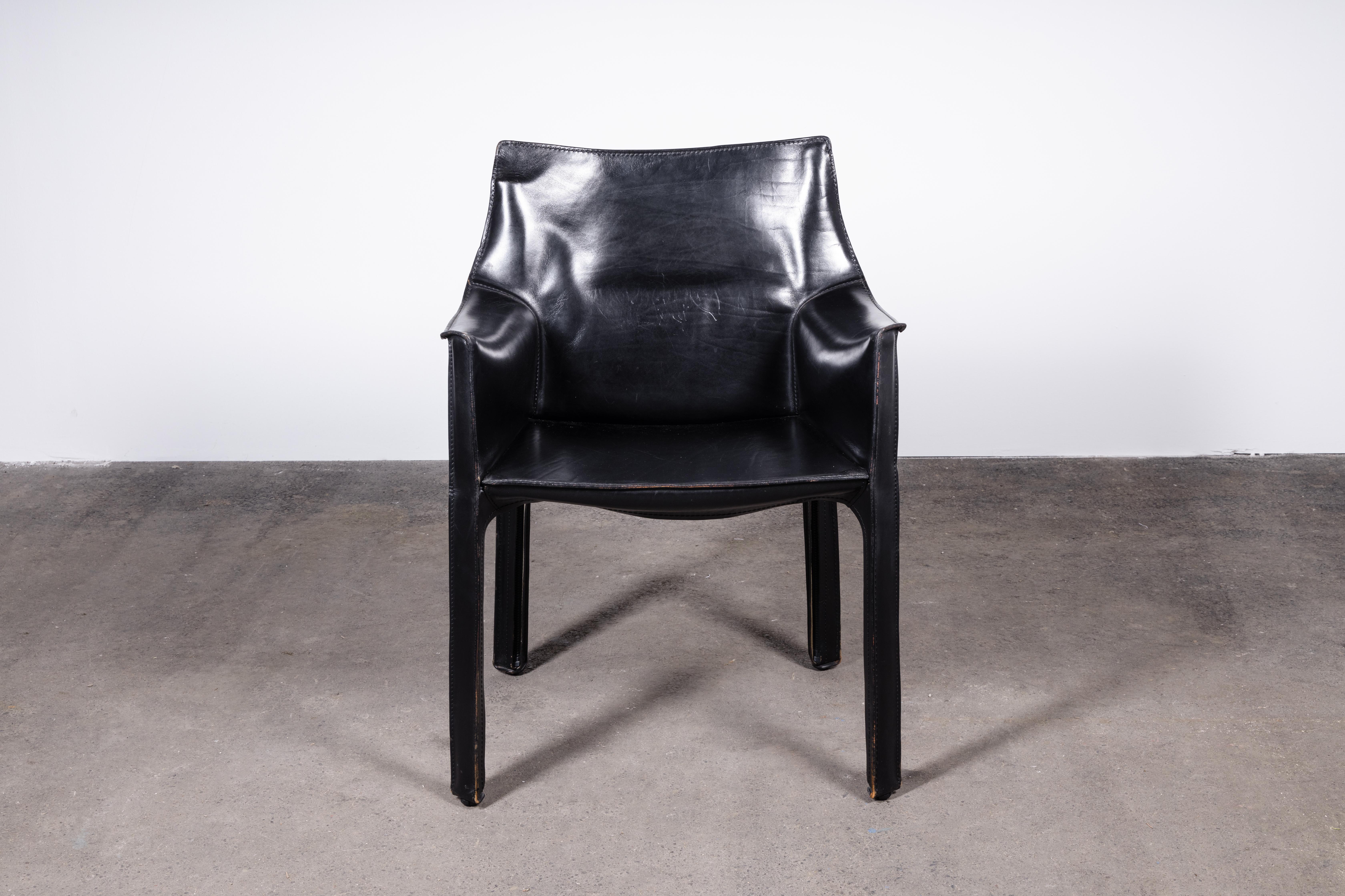 Set of 2 Mario Bellini 414 CAB armchairs. Made by Cassina in Italy in the 1980s. 

Flexible steel frame covered with a skin of high quality black saddle leather. This elegant, versatile chair is equally suitable for the dining room, study or