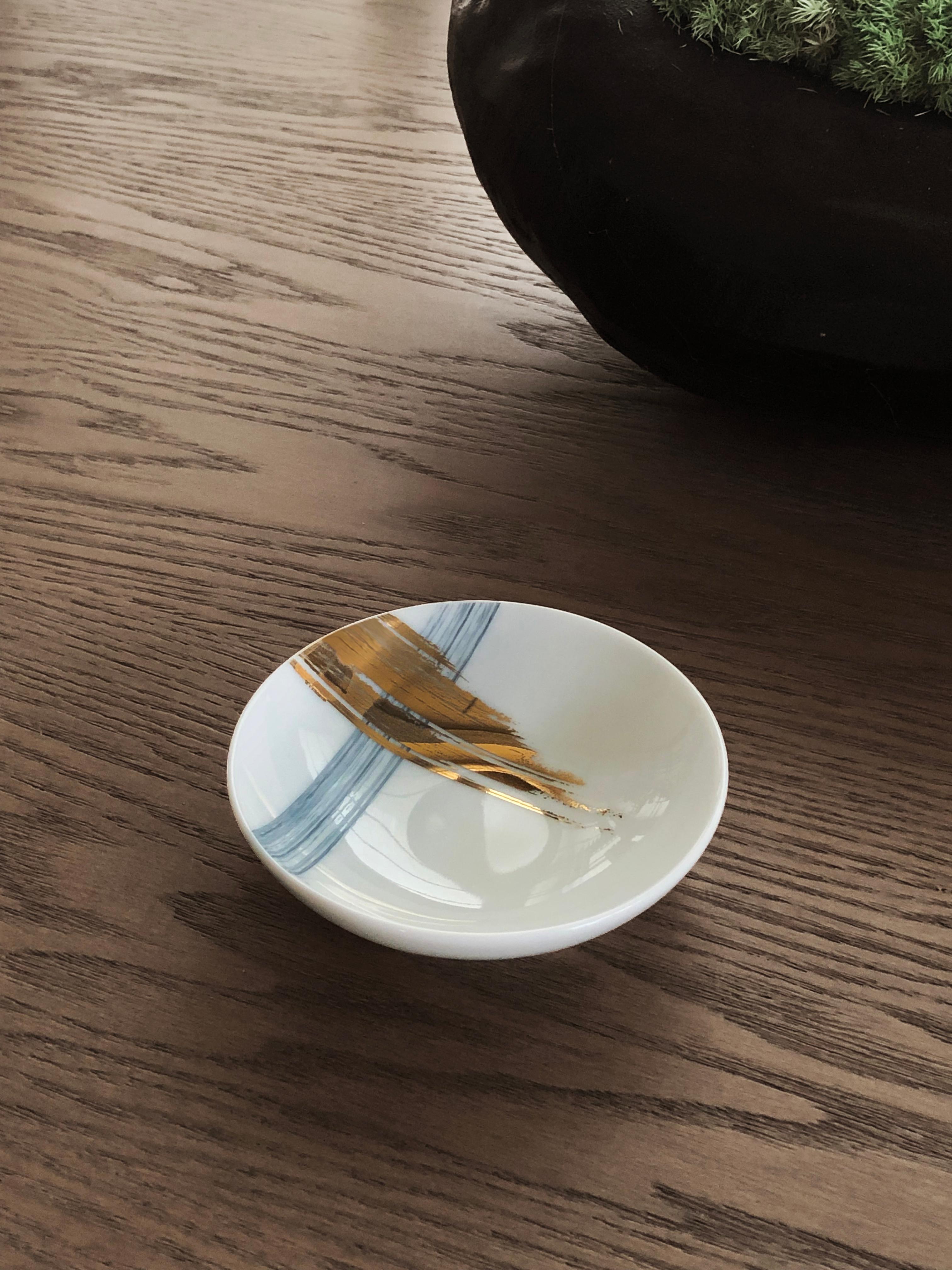Larger quantities available upon request, with 8 weeks production time.

Description: Set of 2 medium sauce plate (2 pieces)
Color: Blue and gold
Size: 9 Ø x 2.5 H cm, 60 ml
Material: Porcelain and gold
Collection: Artisan Brush.