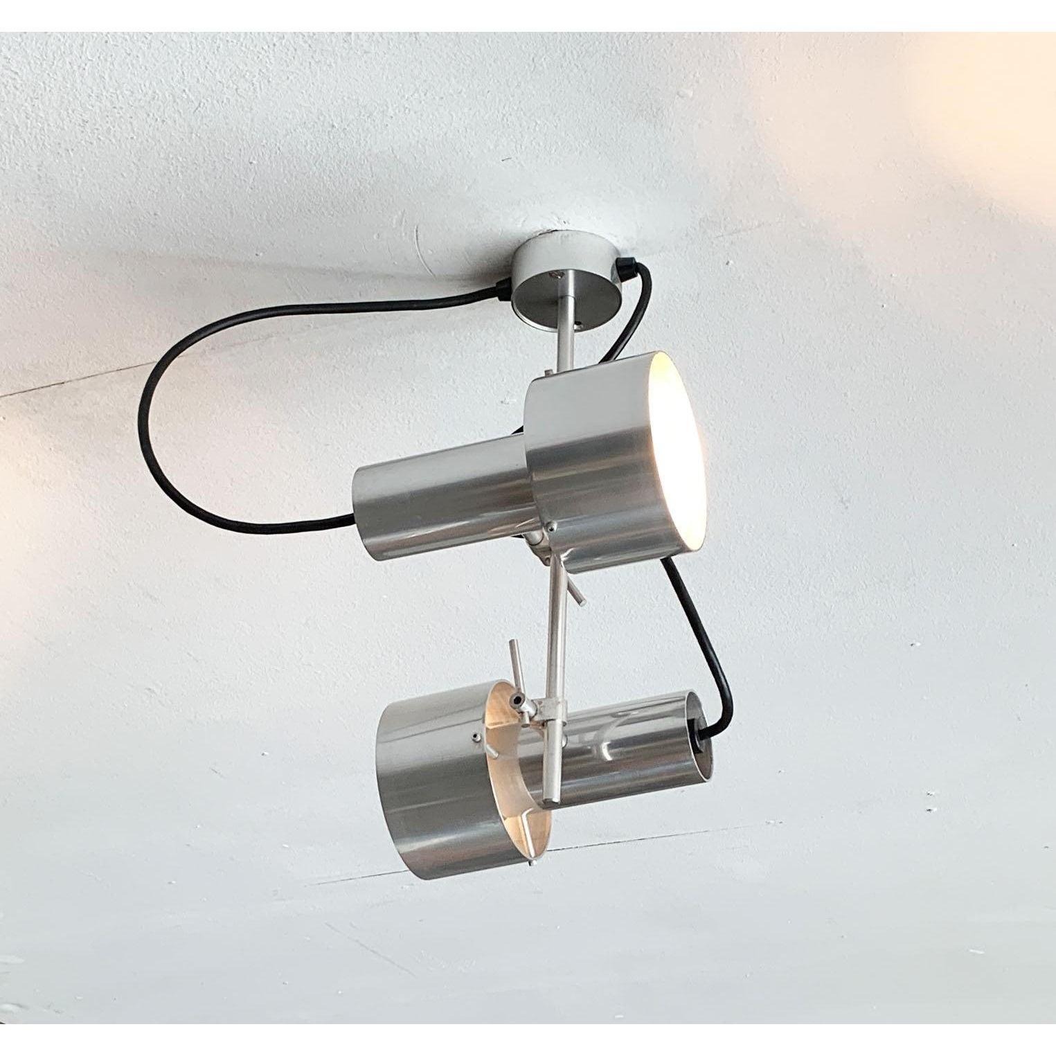 Rare plafonnier double d'Architectural Lighting d'après un design du célèbre designer industriel Peter Nelson datant des années 1960.

Le langage et la matérialité des designs de Nelson reflètent son passé dans l'industrie aéronautique. L'aluminium