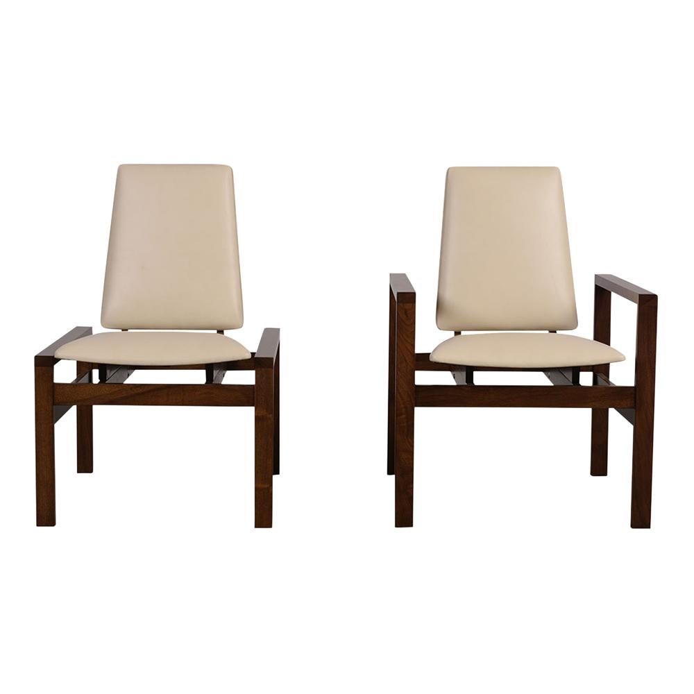 This set of two modern style lounge chairs by Brown Saltman features a walnut wood frame stained in a rich walnut color with a lacquered finish. The frames with a unique design allow for the backrest to adjust and move to accommodate whoever may be